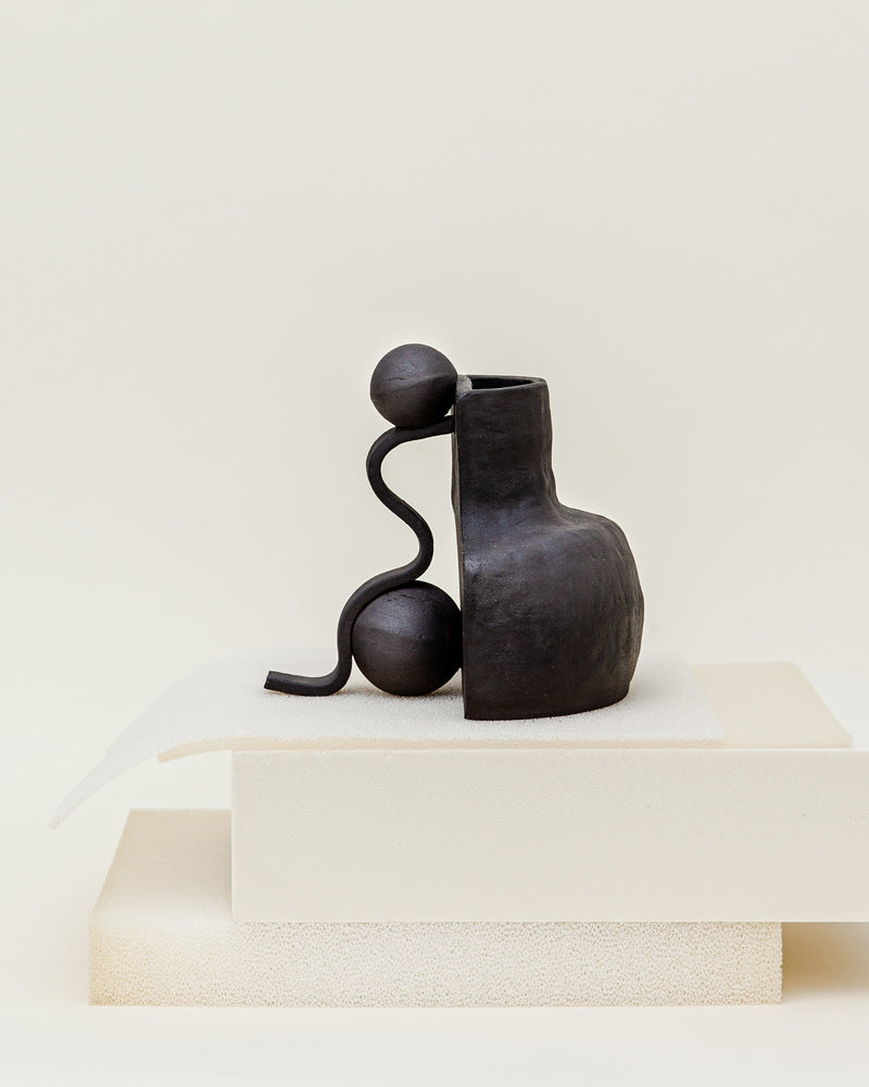 Black ceramic Fragment vase with curved handle and spherical elements
