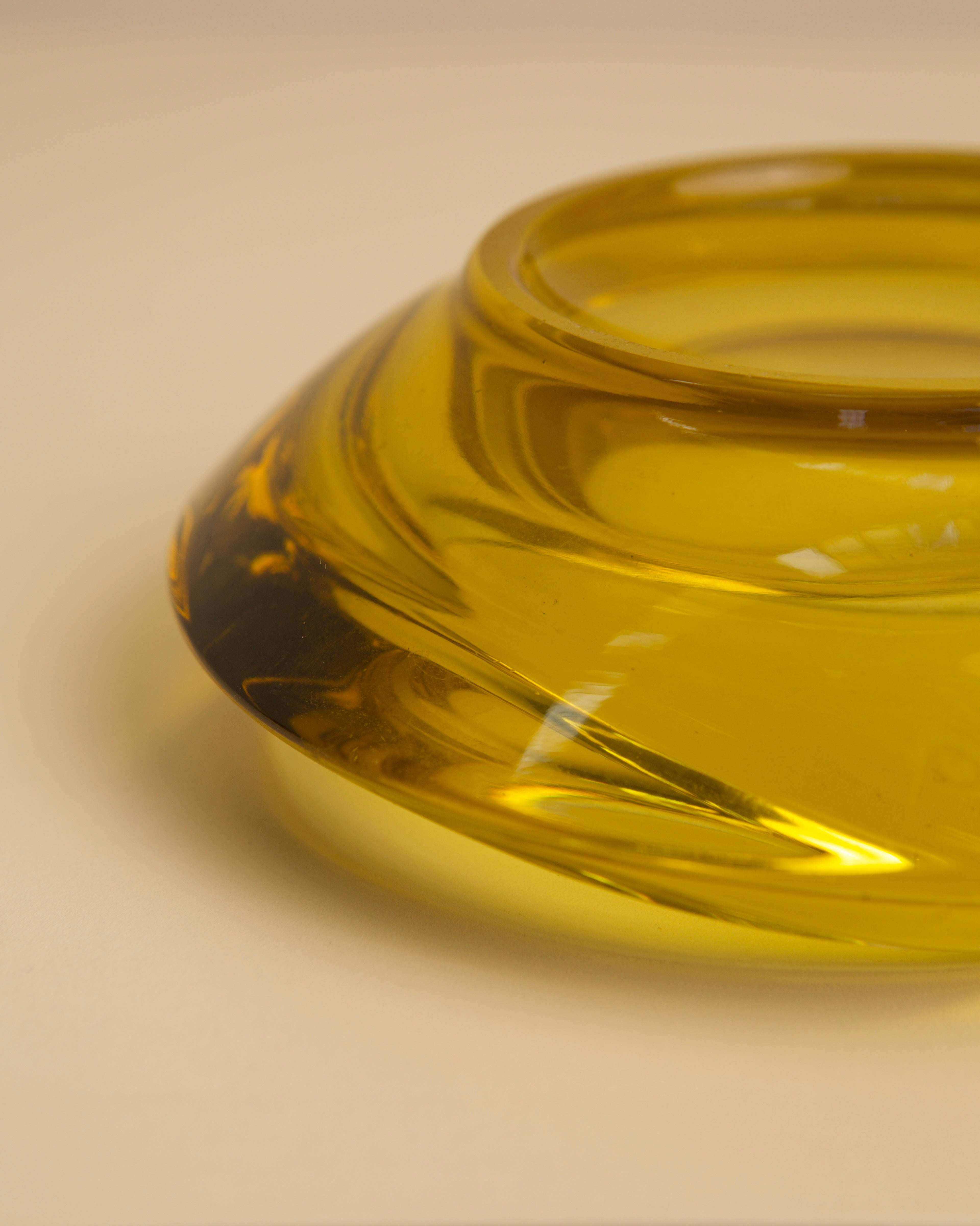 Close-up detail of amber Murano glass vide-poche curved form