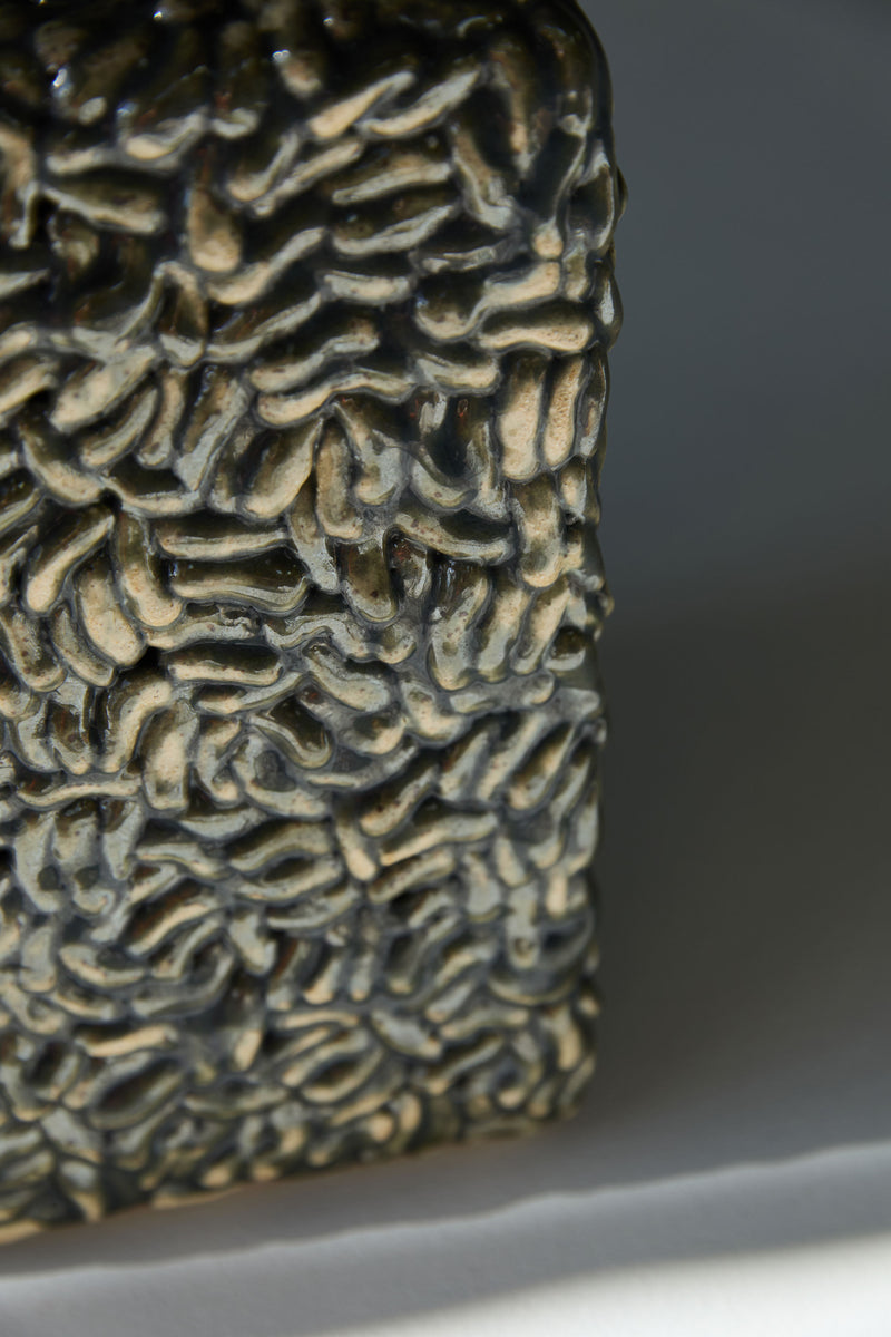 Close-up detail of iridescent ceramic texture on Molecules vase