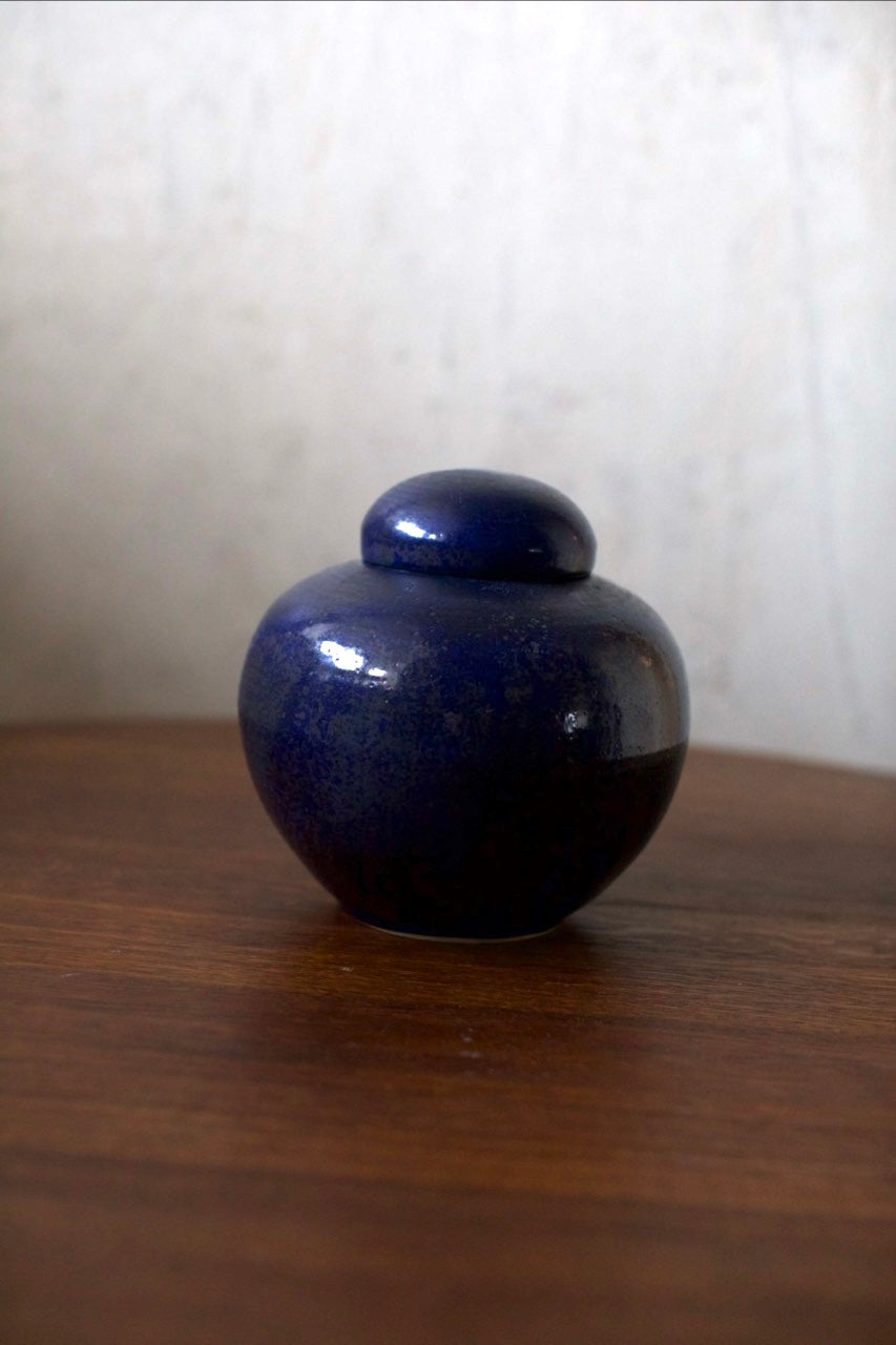 Ceramic Bowl — side angle showing deep blue glaze on wooden table