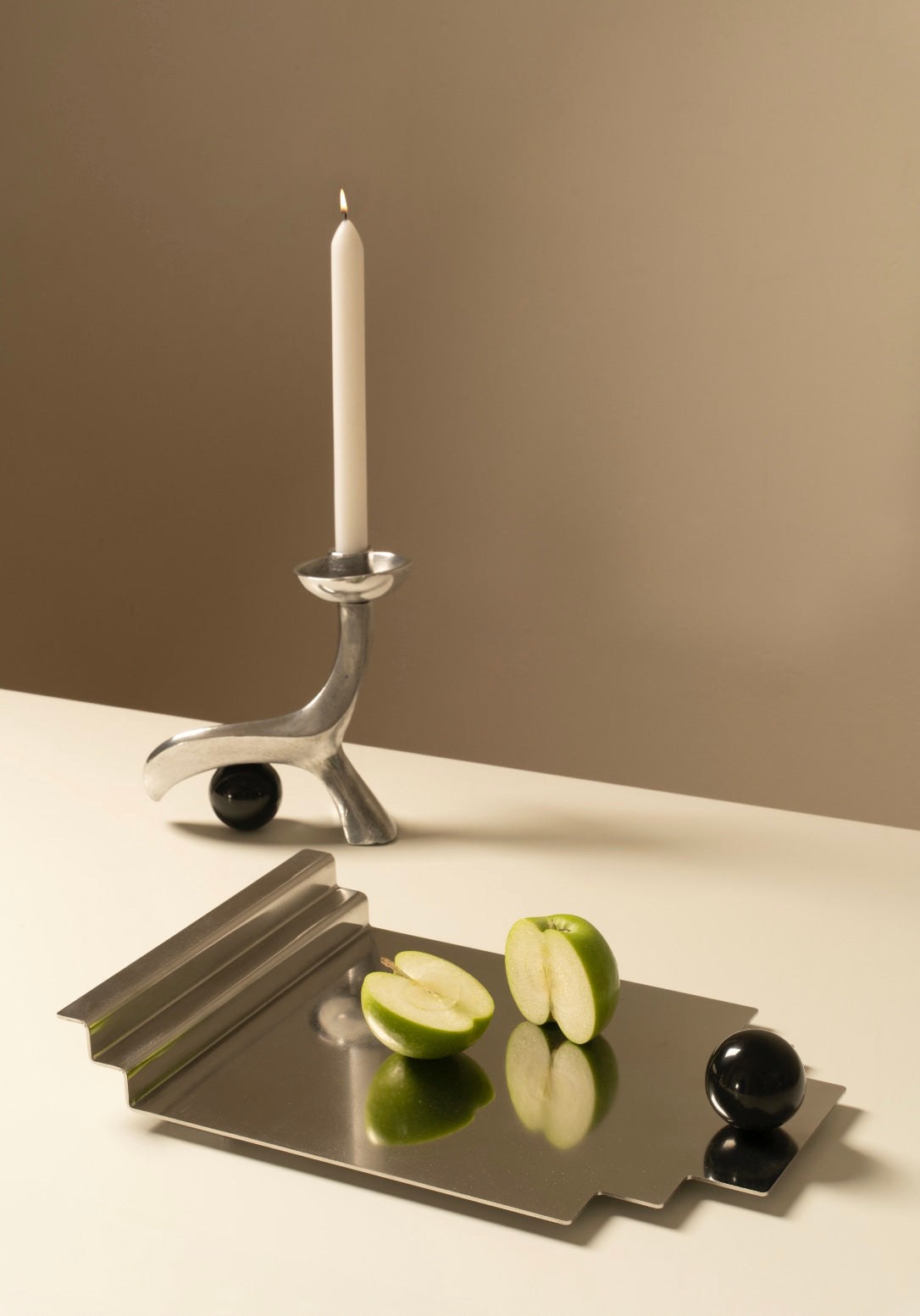 The Linea Candleholder — side angle with silver finish and candle