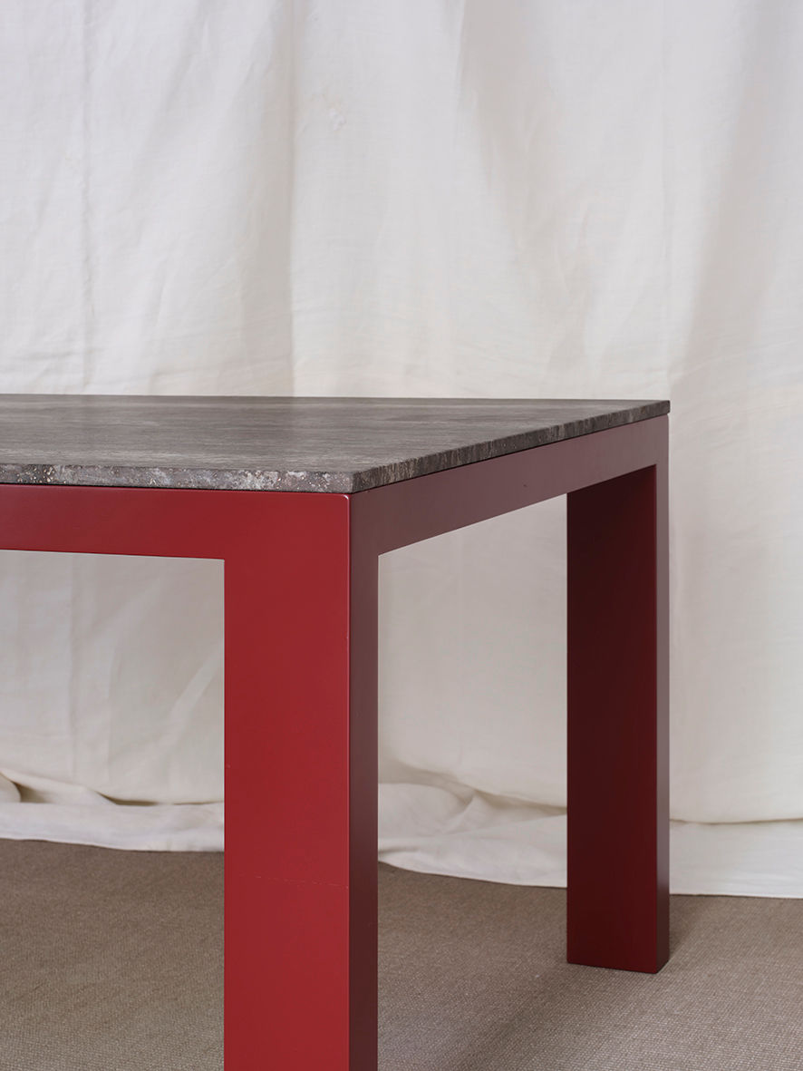 Firme Dining Table — back view highlighting red legs and dark top