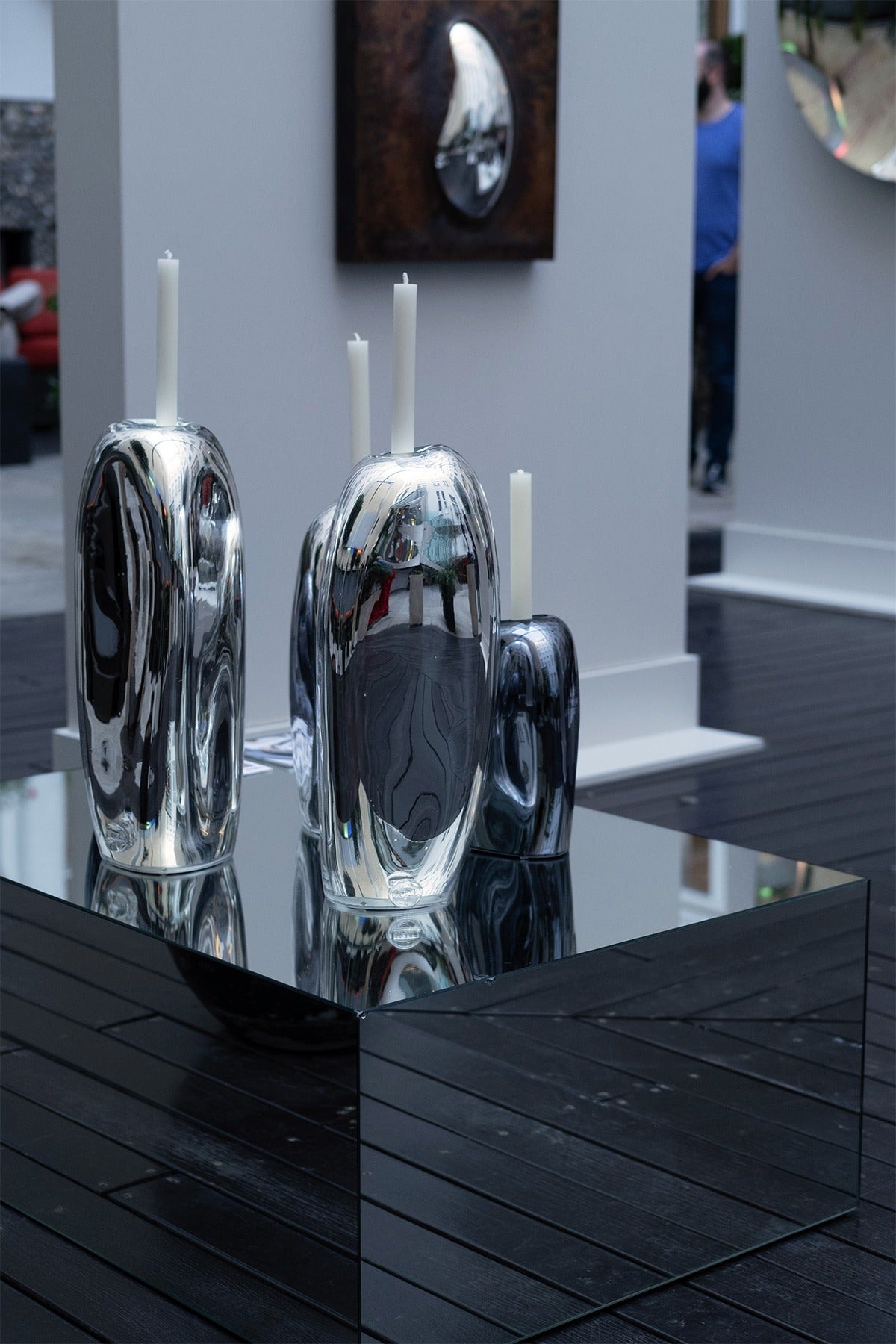 Lumos Candle Holders — reflective silver surface on modern display table