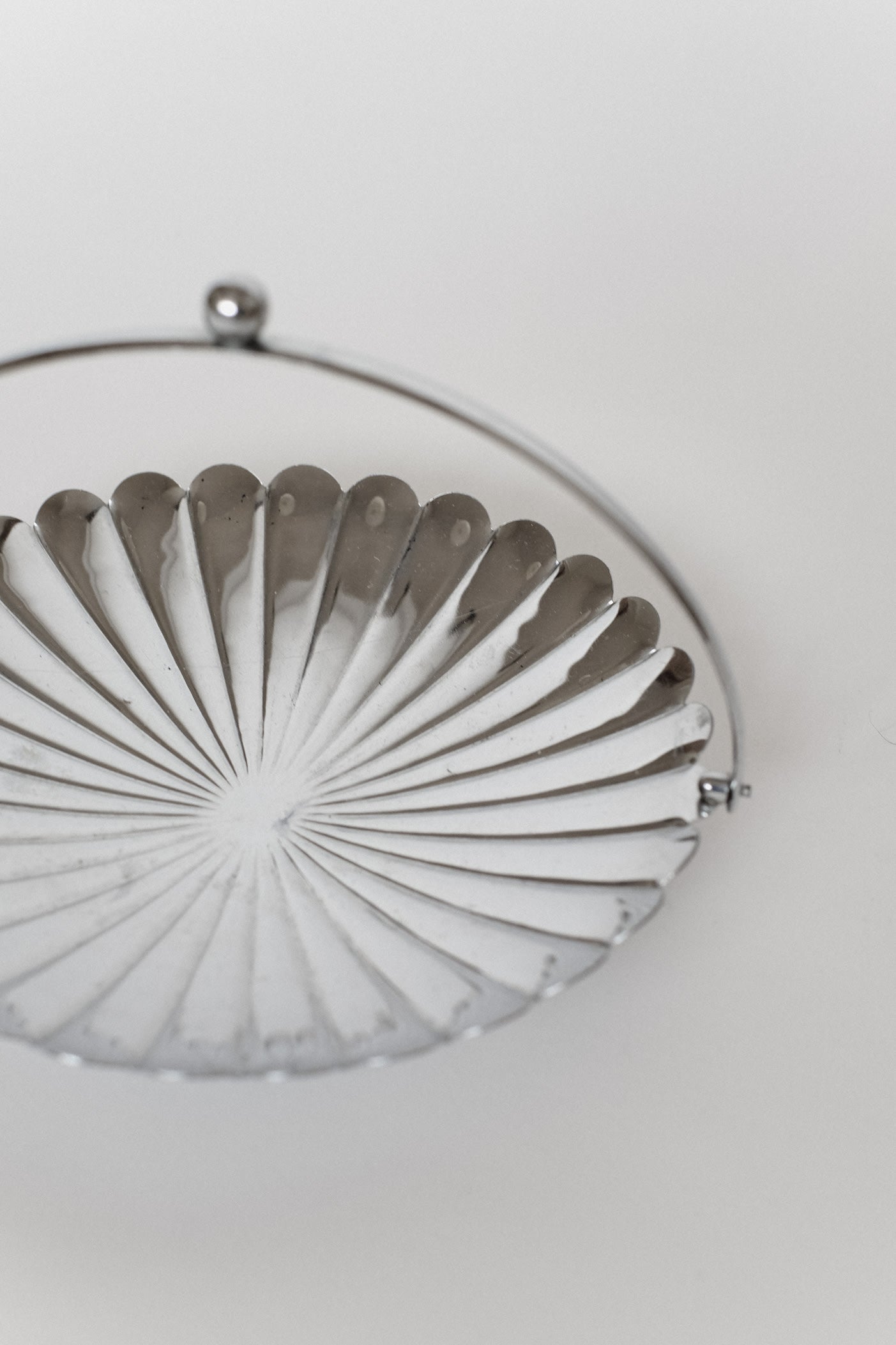 Serving Dish With Handle — side angle of polished metal surface