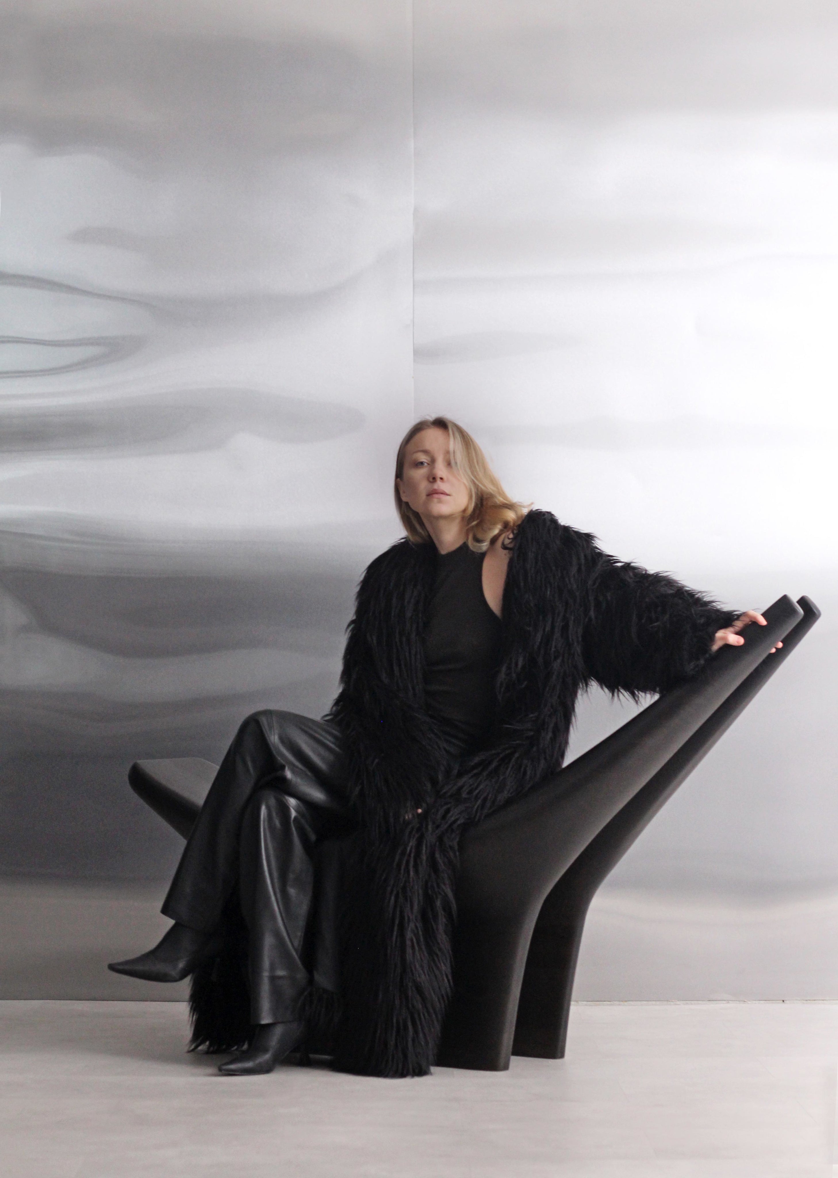 Dym Lounge Chair — side angle with black finish in modern setting