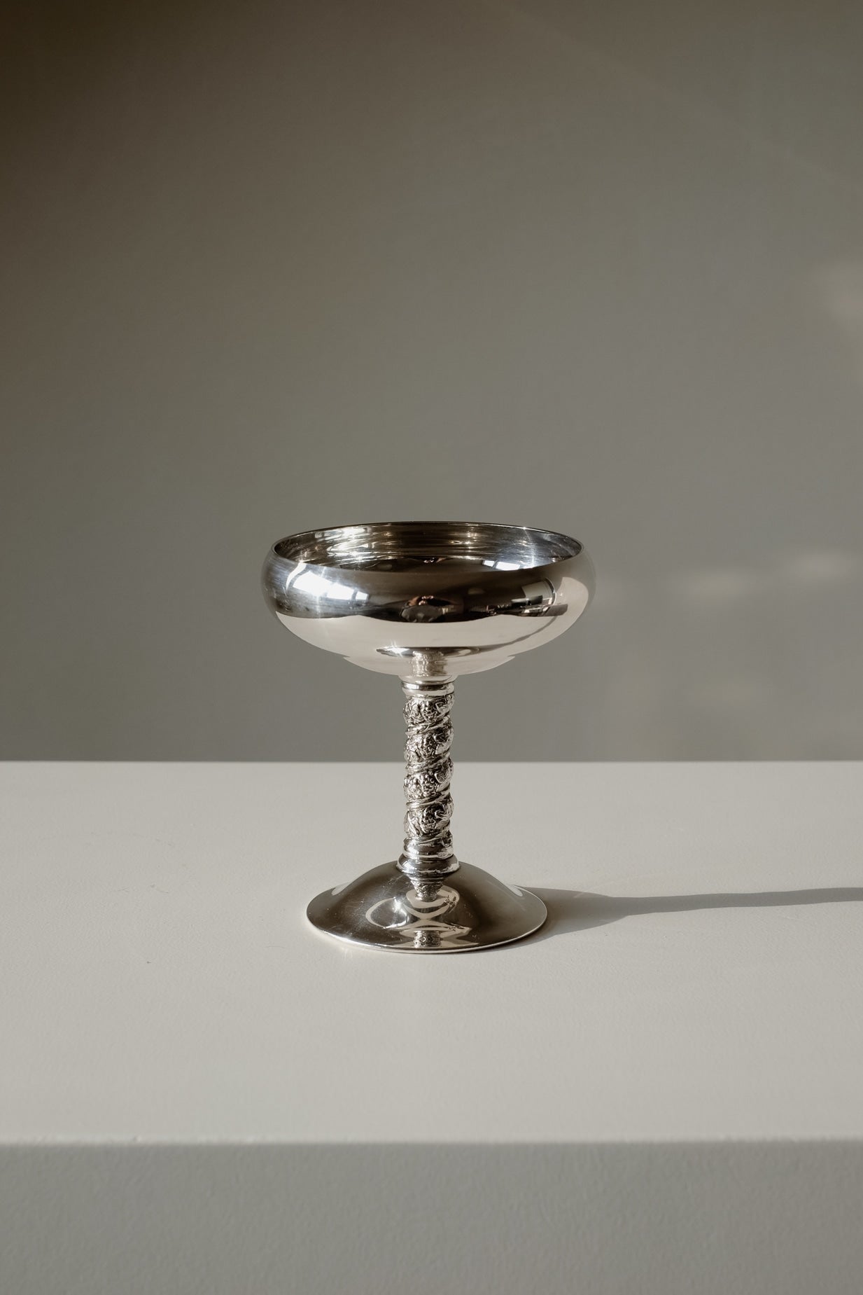 Set of 6 Silver Coupes — close-up of polished silver cup on white surface