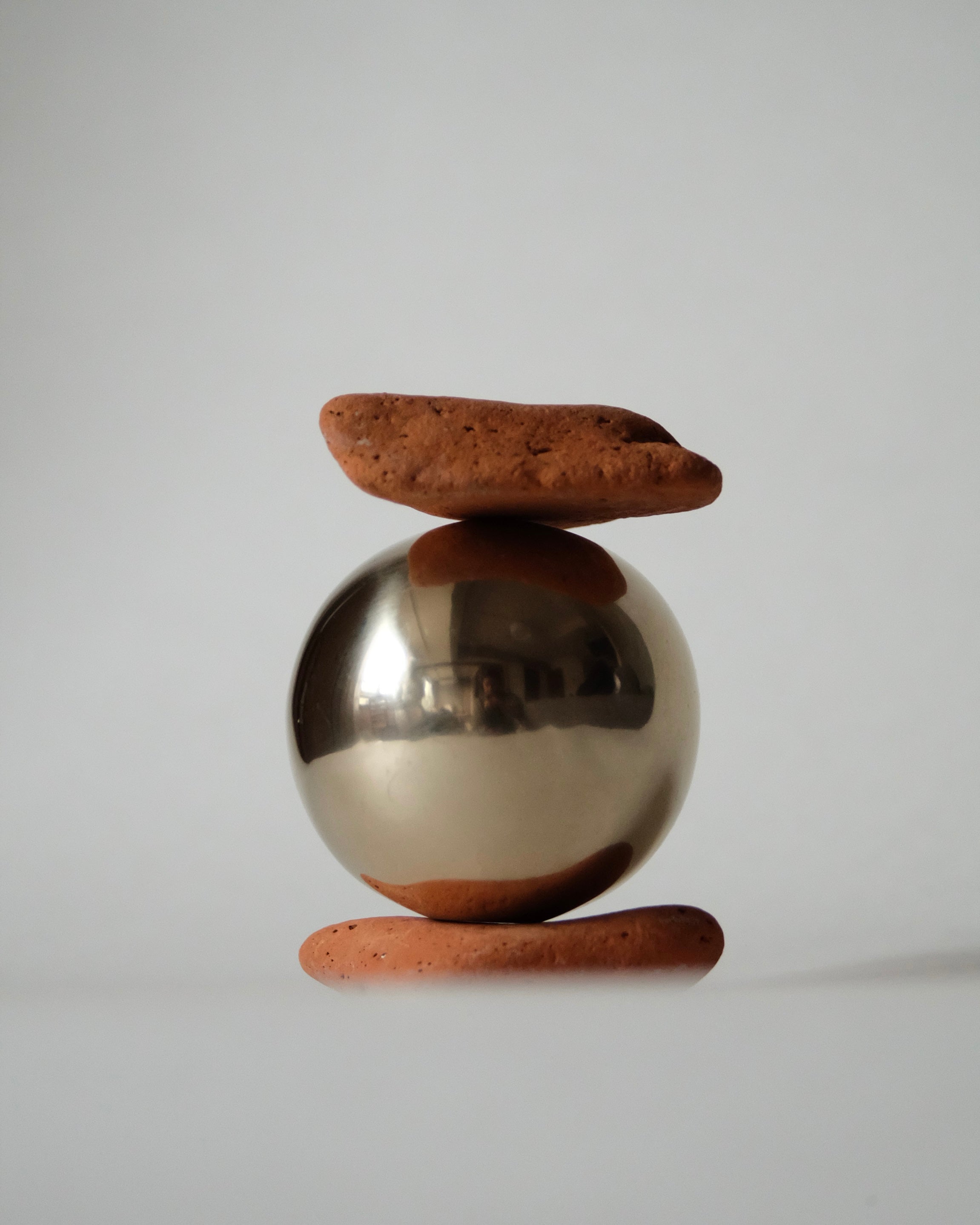 CERCLE Cabinet Knob Large — top view of polished brass knob on clay base