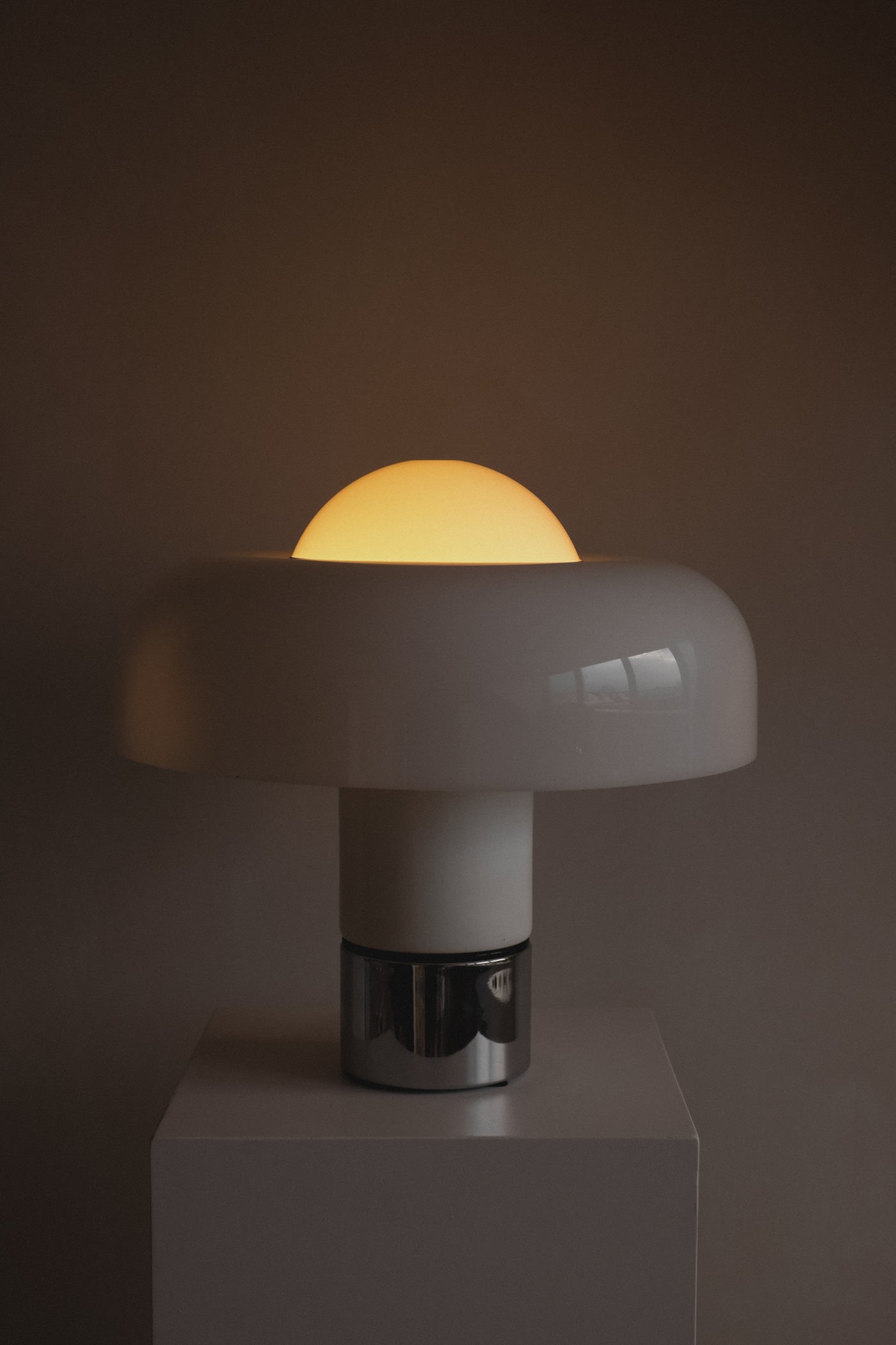 Brumbry Table Lamp by Luigi Massoni for Harvey Guzzini — close-up of white dome shade with warm glow