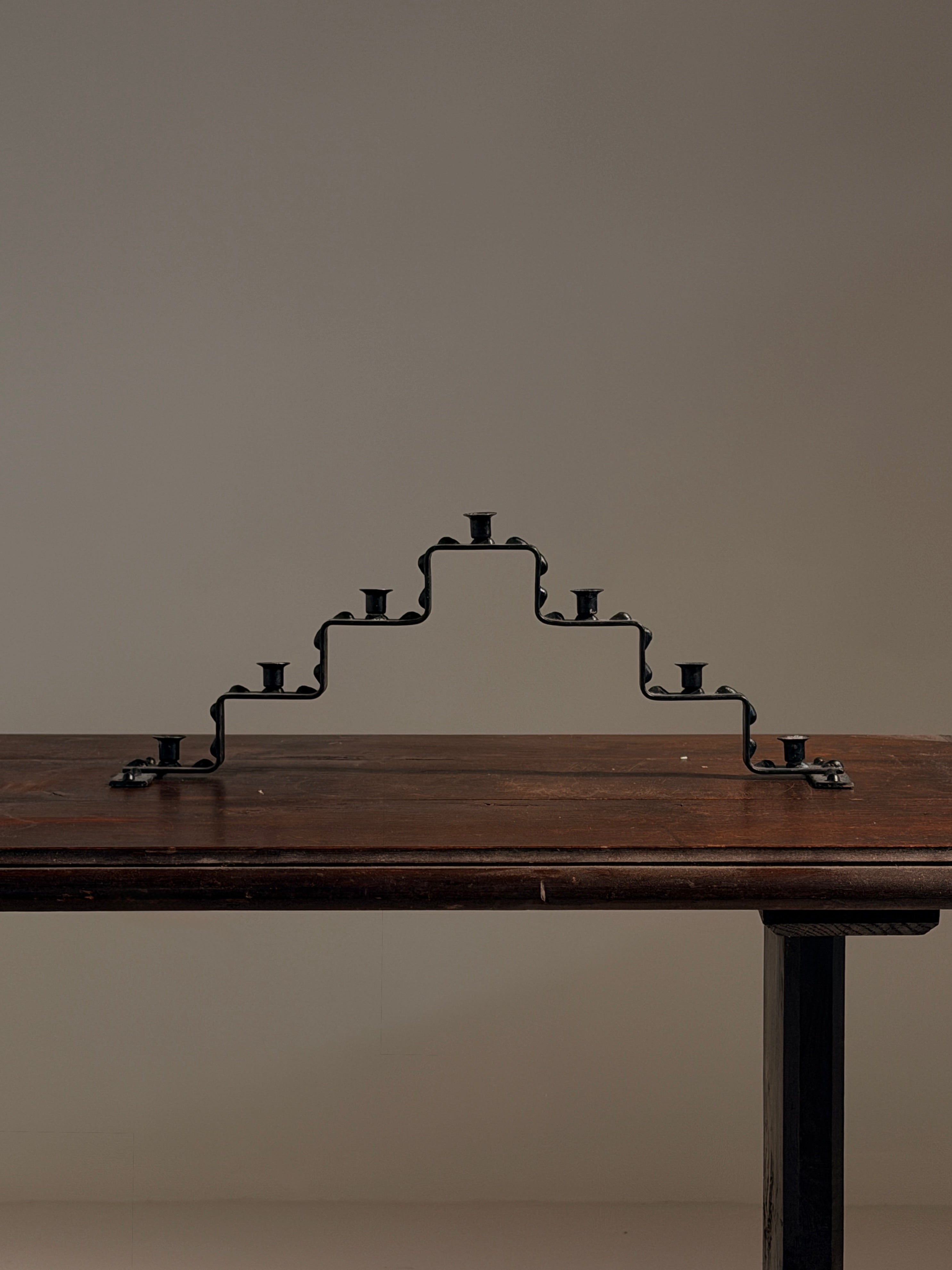 Seven-light geometric candelabra in black iron, circa 1960 — side angle