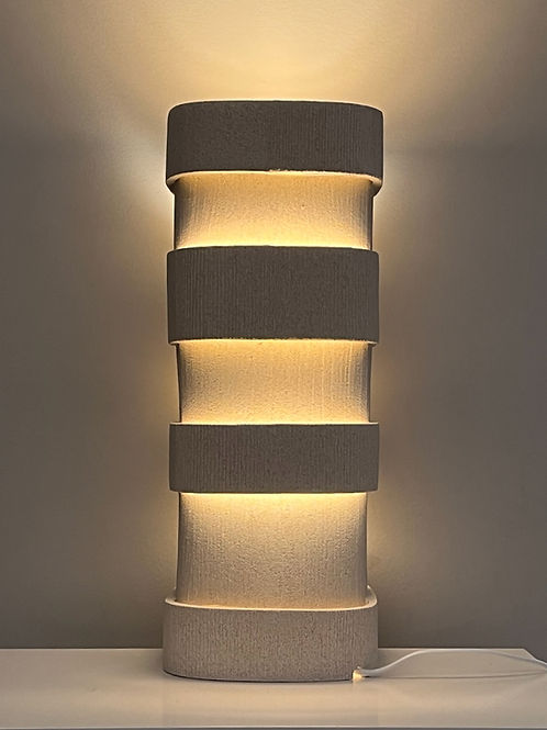 Contemporary Table Lamp in Ceramic — angled view with warm light glow