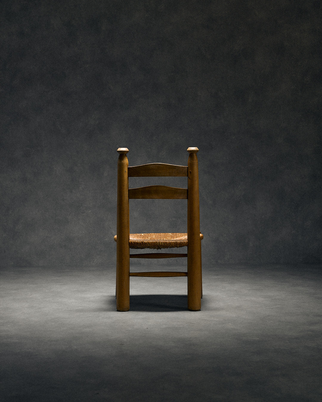 low chair with rush seat, attributed to Charles Dudouyt — lifestyle setting