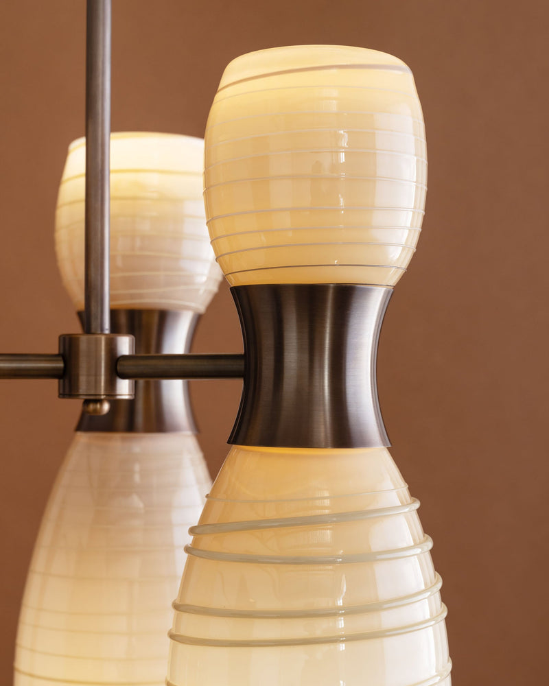 Close-up detail of Taff pendant light's ribbed glass shade and brass fitting