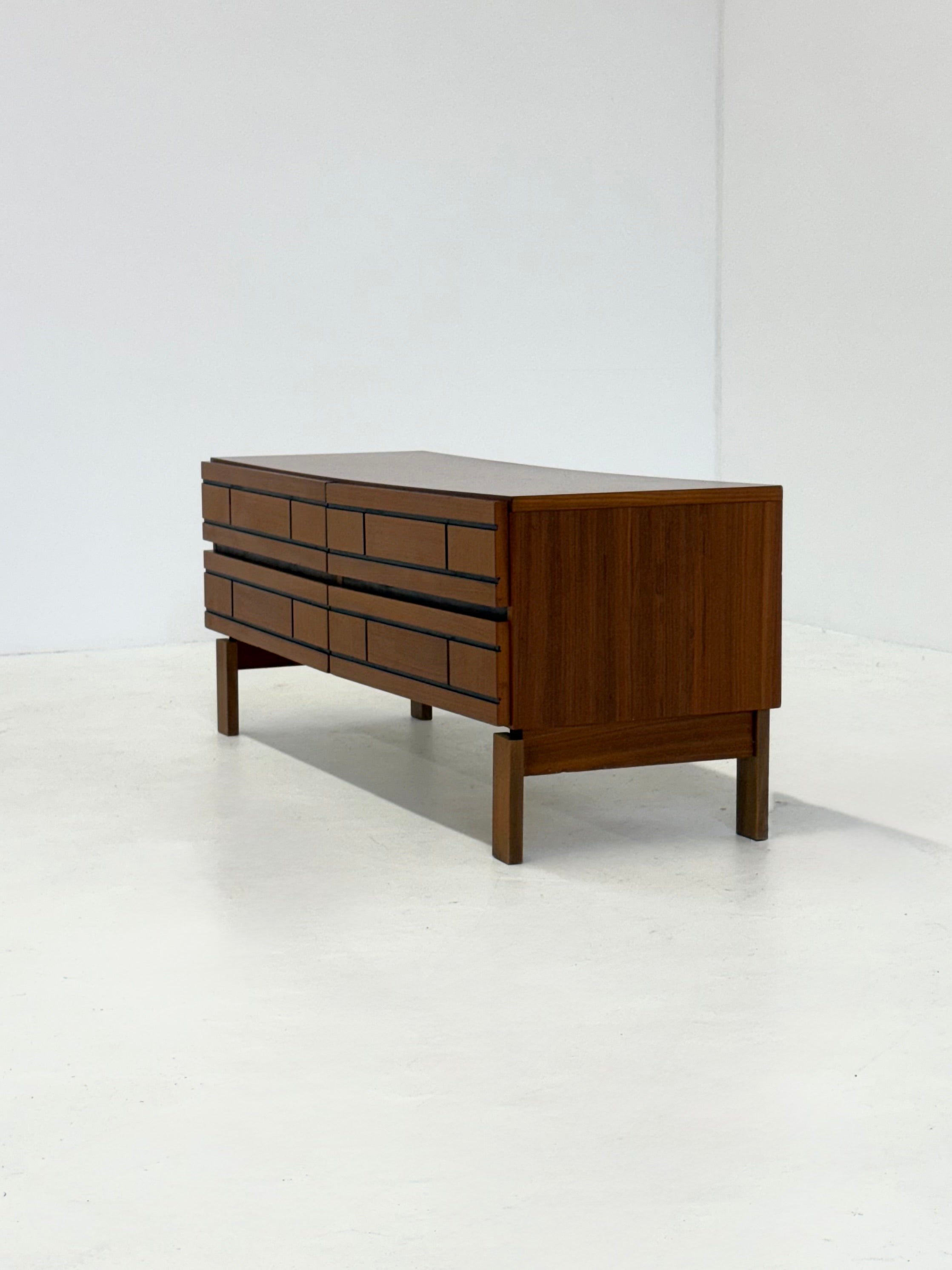 Low Italian wooden sideboard with graphic black lines — close-up
