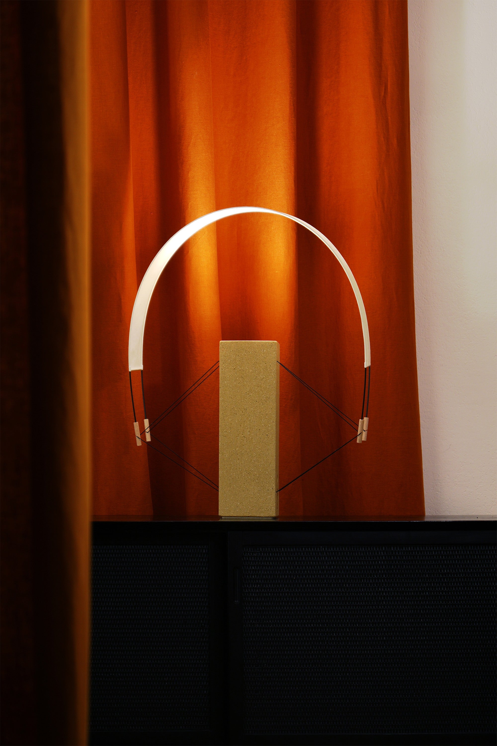 Coastal Modern Table Lamps in Raw clay - Lumia - Collection Aura — lamp on dark console with orange curtains