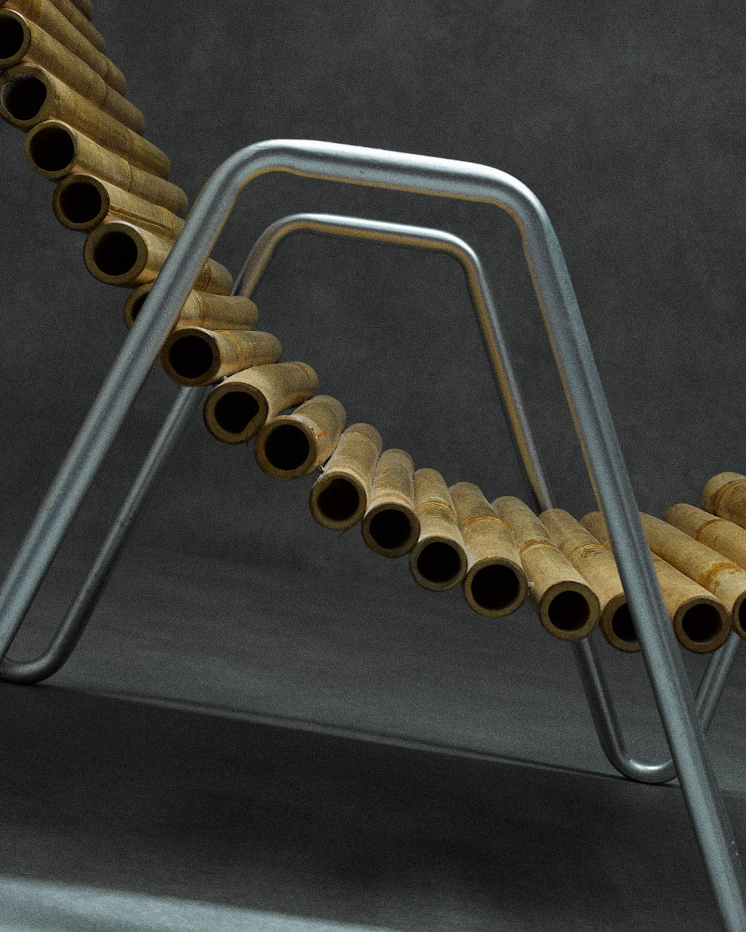 bamboo lounge chair, signed "Hambresin" — close-up of bamboo texture and metal frame