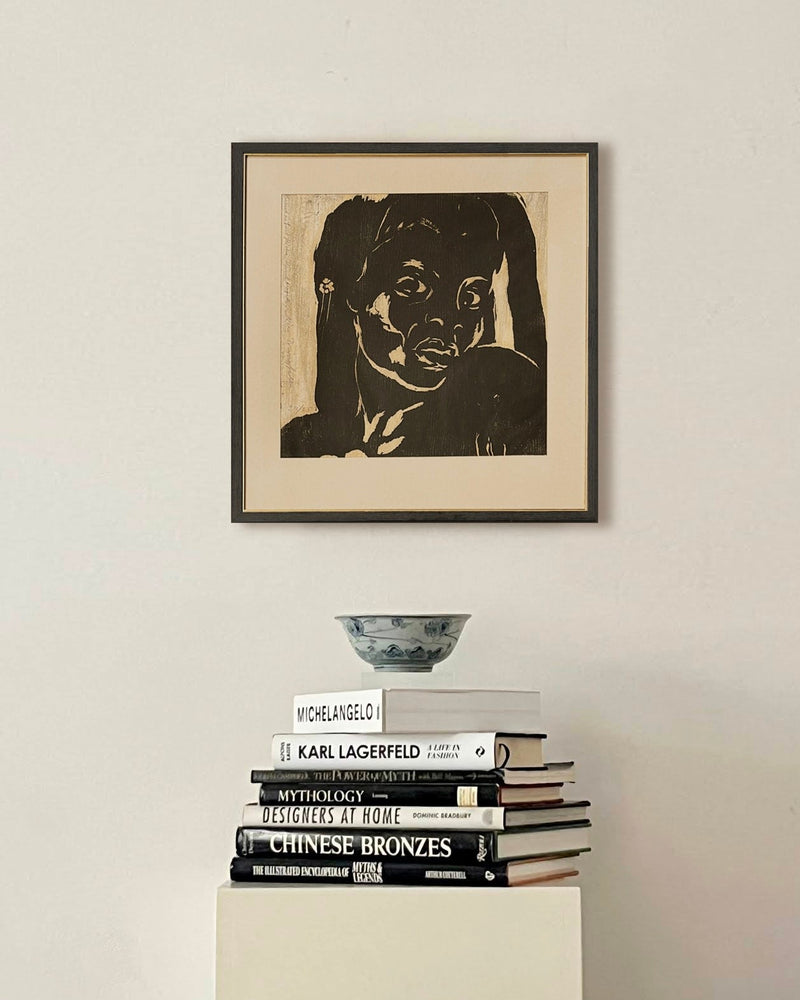Midcentury Woodblock Lithography — framed artwork above stacked books