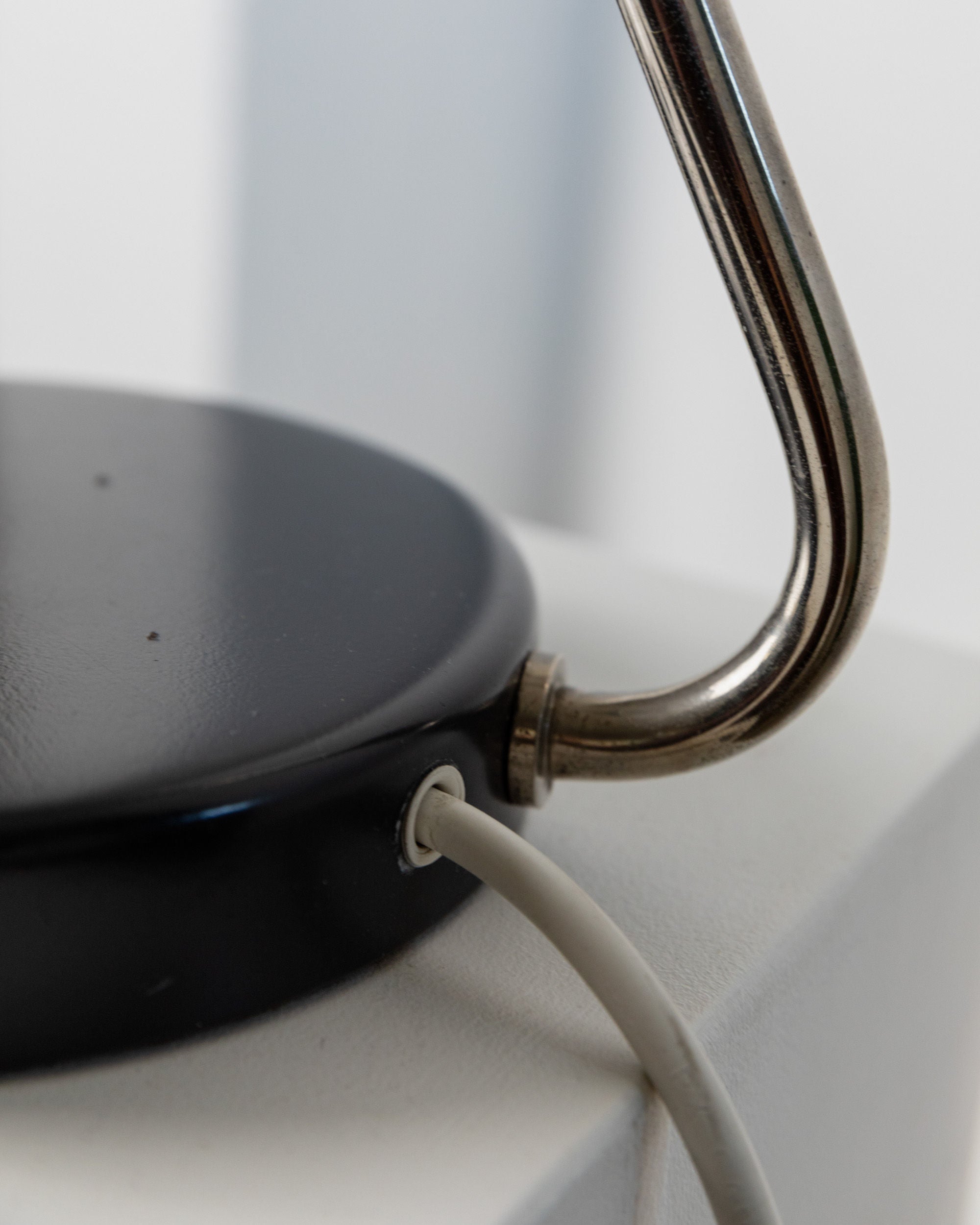 Table Lamp by Kaiser Idell, 1960s — close-up of black base and metal arm