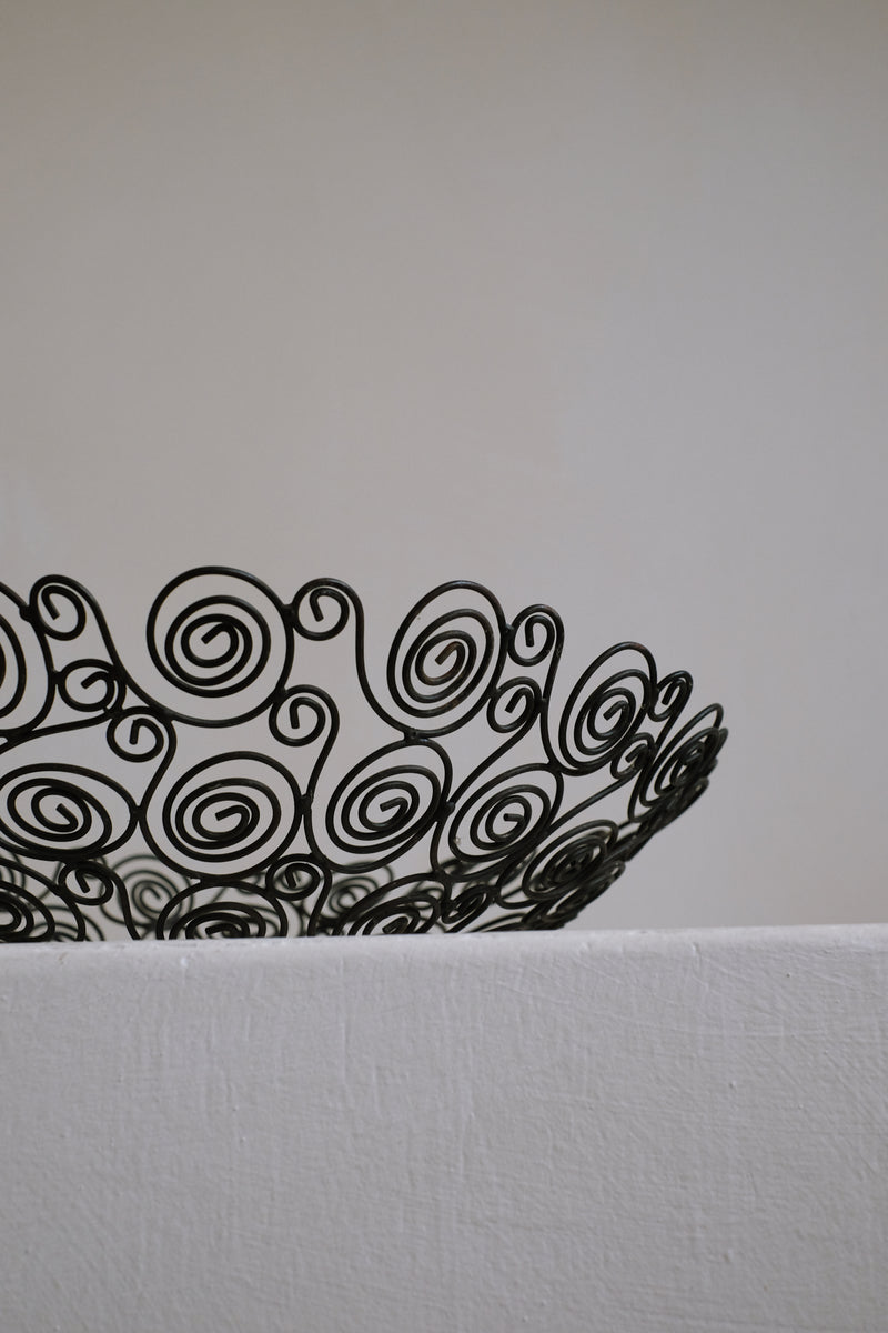 Black wire decorative bowl with spiral pattern detail view