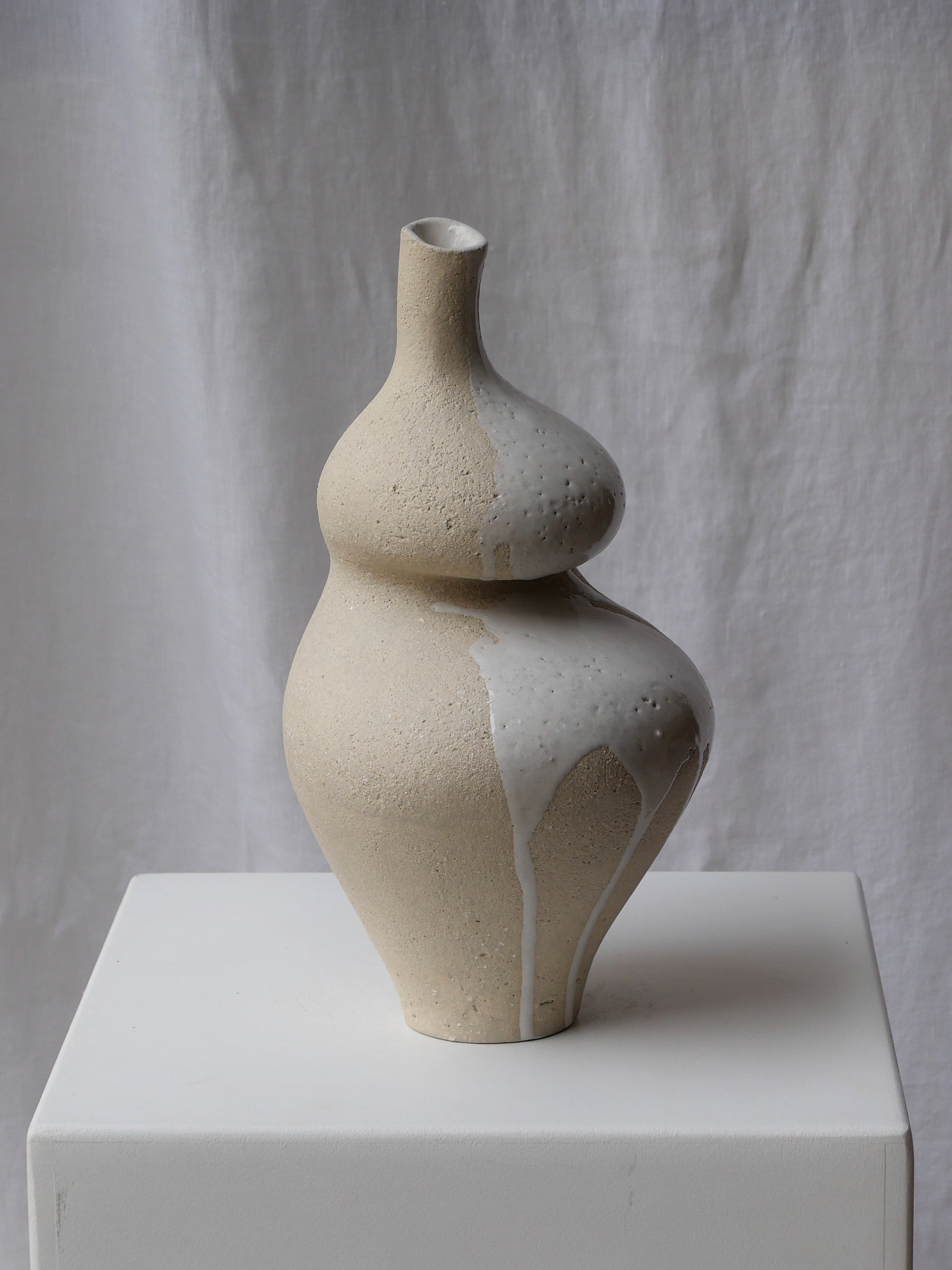 Modern ceramic sculpture with bulbous stacked forms in cream white
