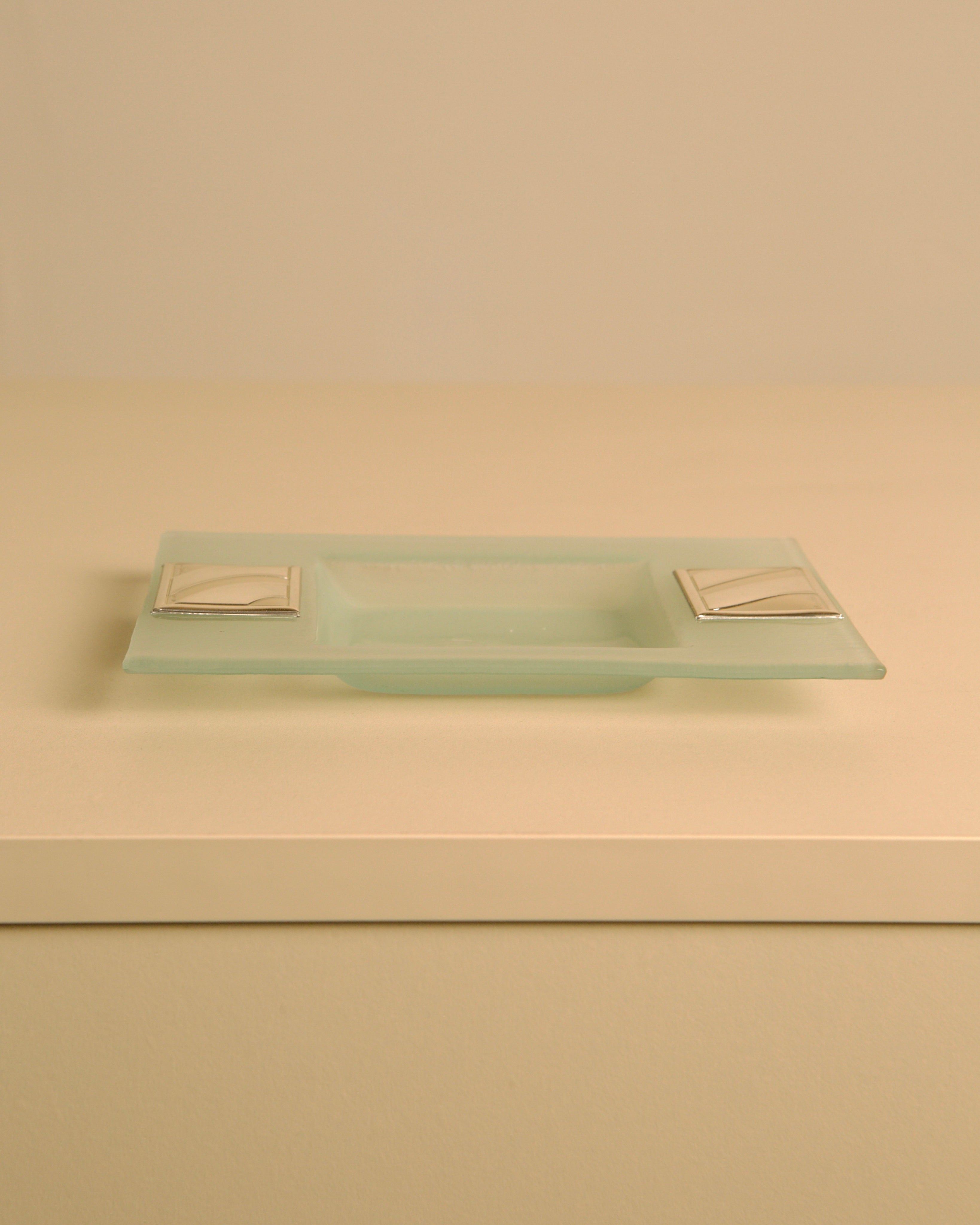Rectangular crystal and silver-plated metal valet tray by Pierre Cardin, 1980s — angled view on neutral background