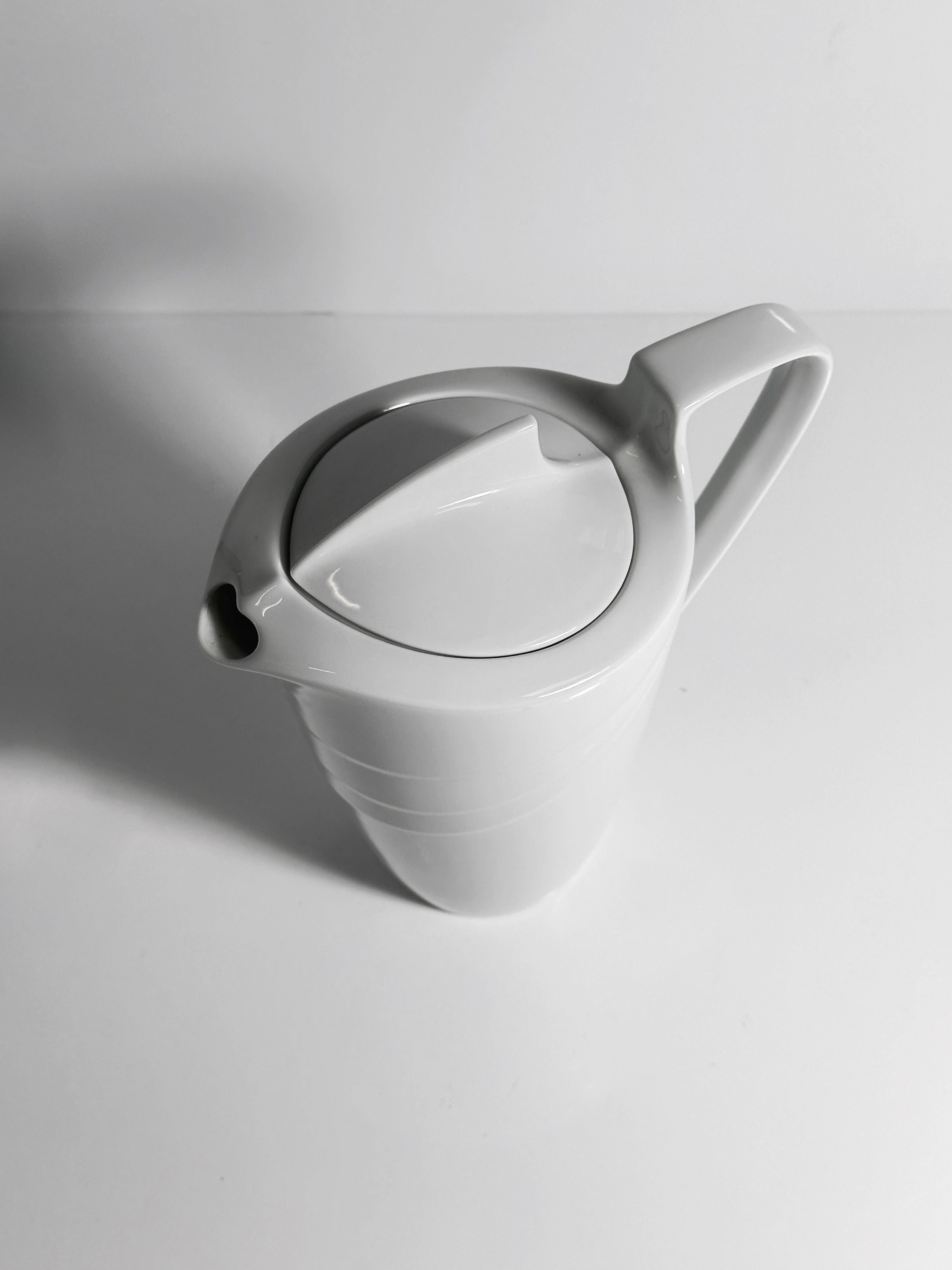White Art Deco porcelain pitcher with curved handle and ribbed base