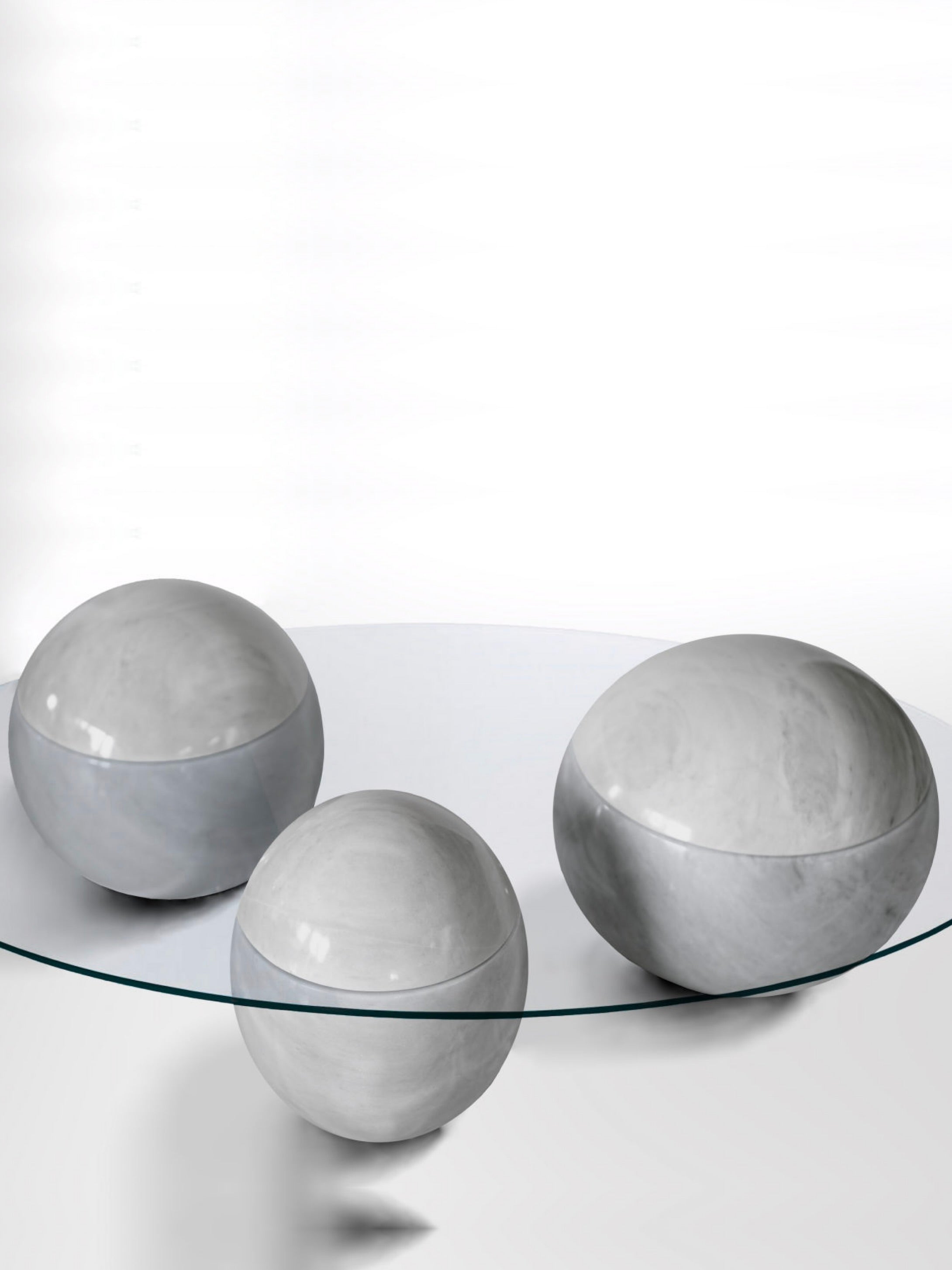 Ovni Uovo' Coffee Table — three gray marble spheres under glass top