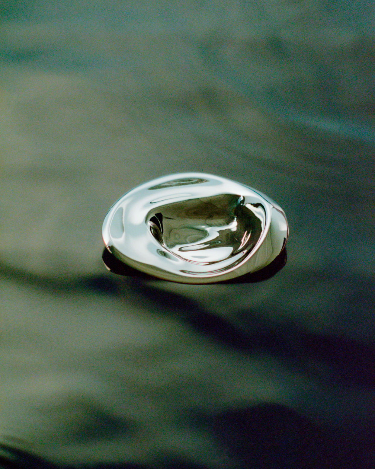 Ripple Hook - Small - Titanium — floating on dark reflective surface