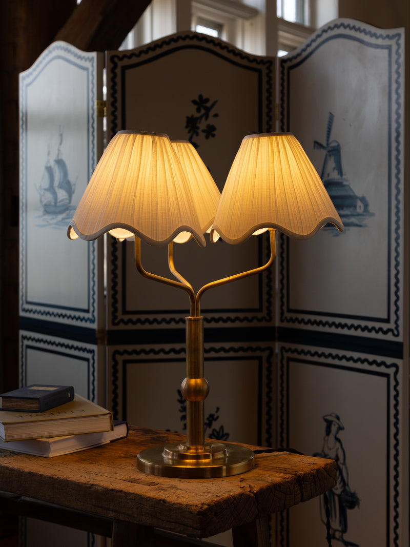 Rosie brass table lamp with dual pleated shades in elegant interior