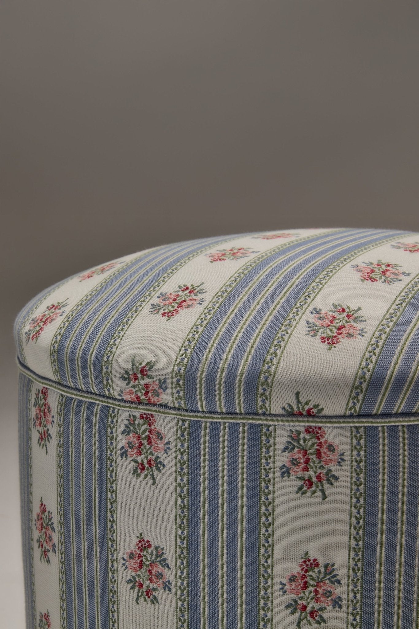 POMONA POEF - SOFA STRIPE 1 — side angle of upholstered floral stool