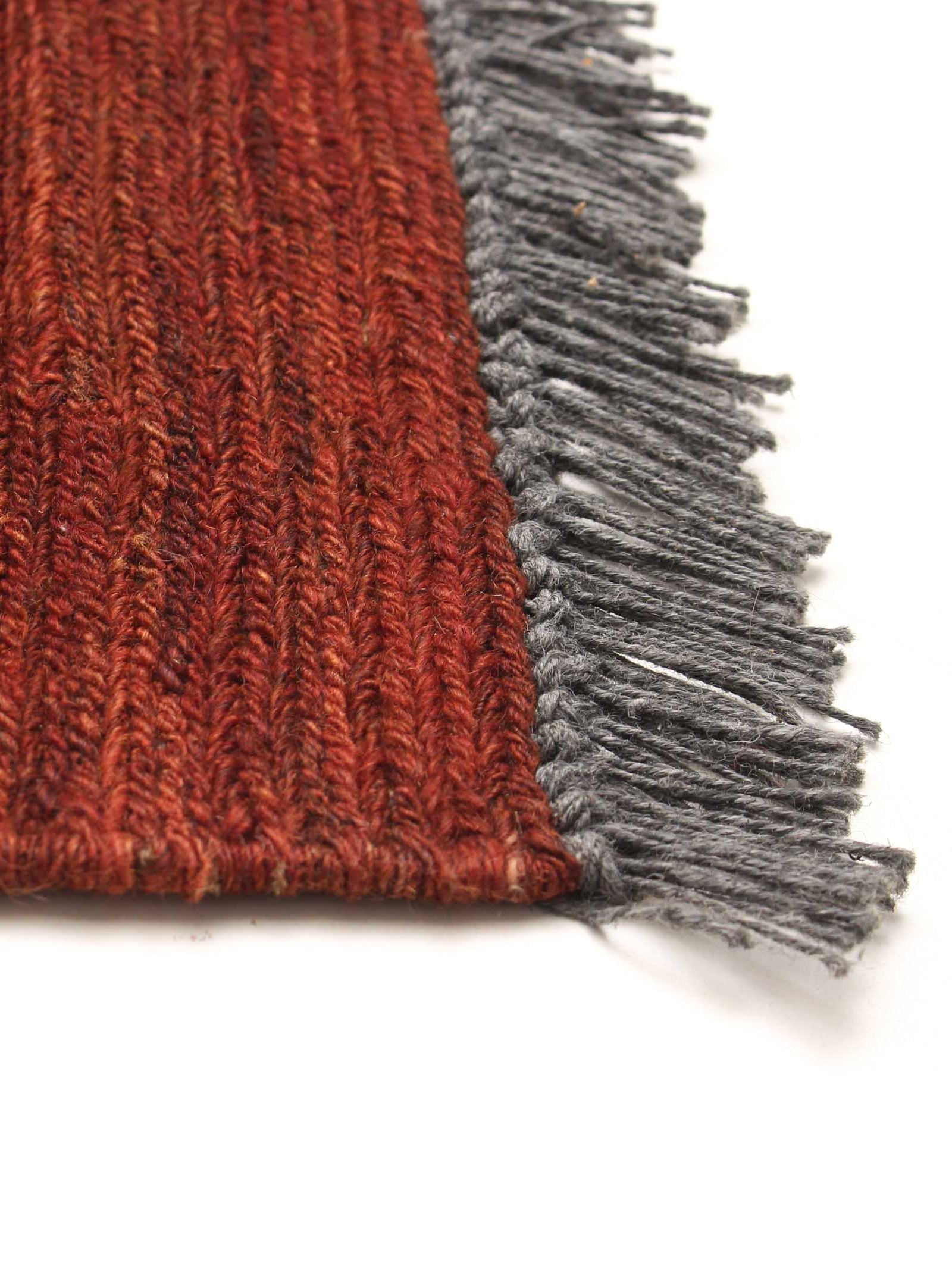 Flatweave Rug in Brick 173 x 240 cm — side angle showing textured fringe detail
