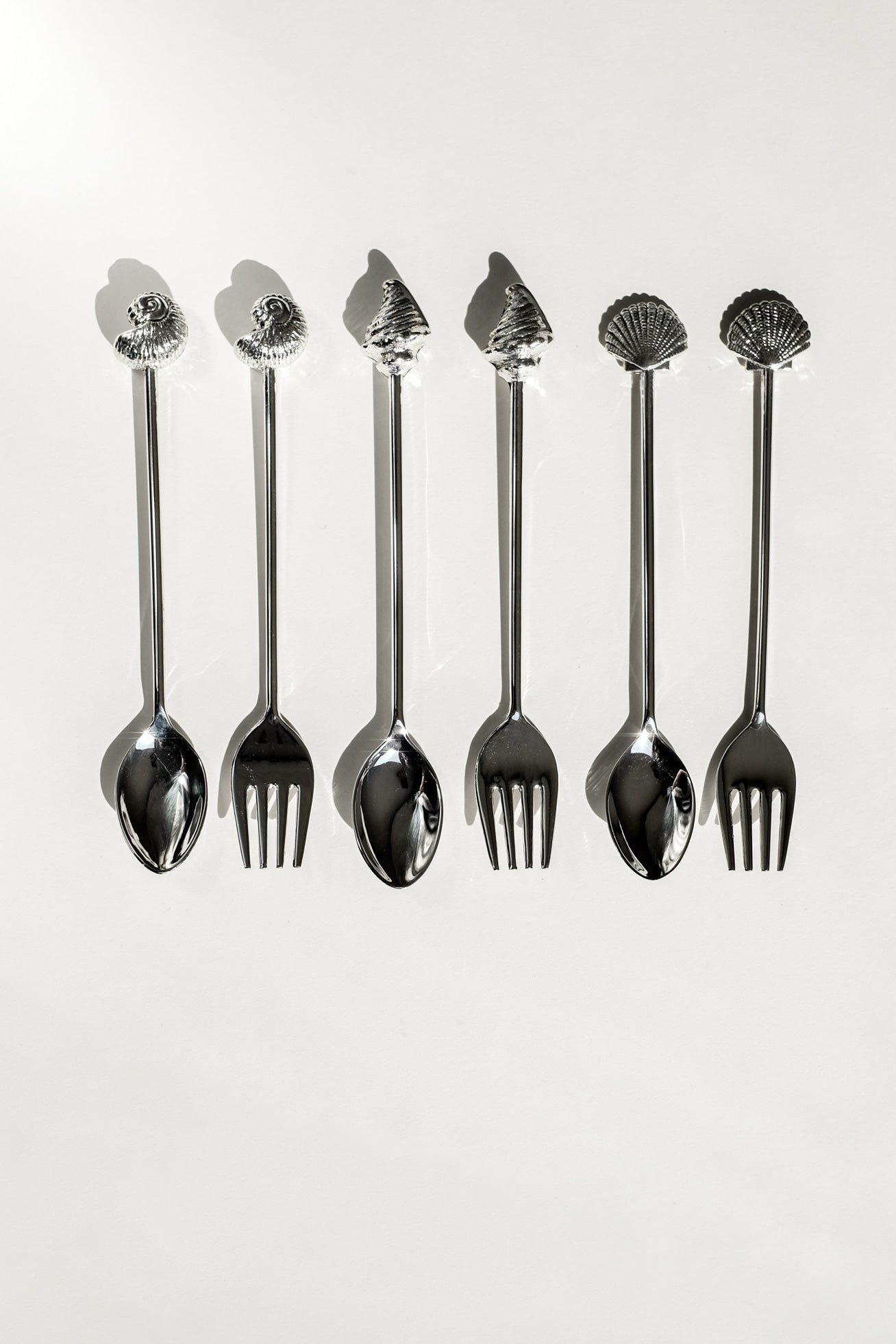 Silver-Plated Seashell Cutlery Set — back view showing five pieces on white background