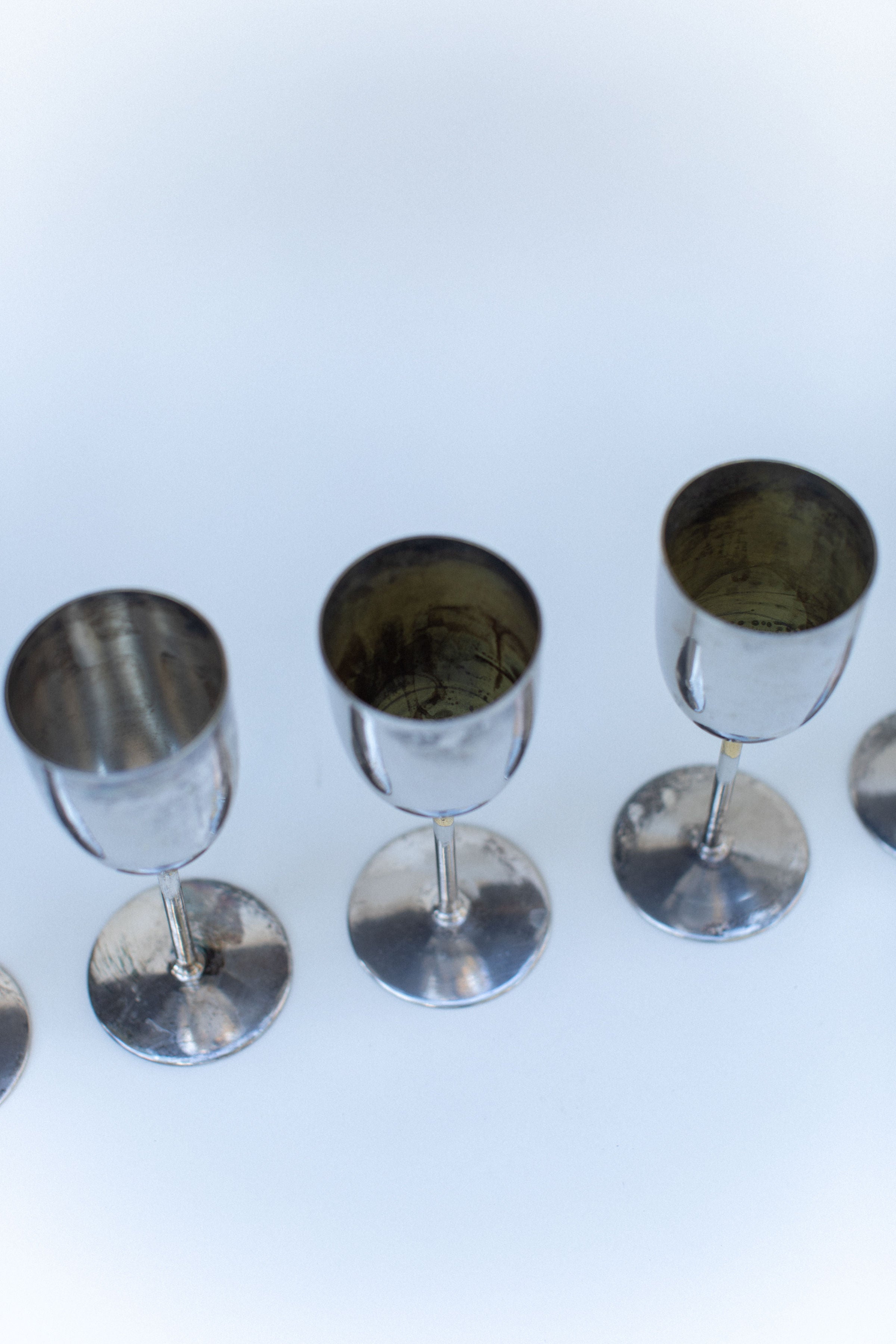 Brass champagne glasses showing reflective interior detail