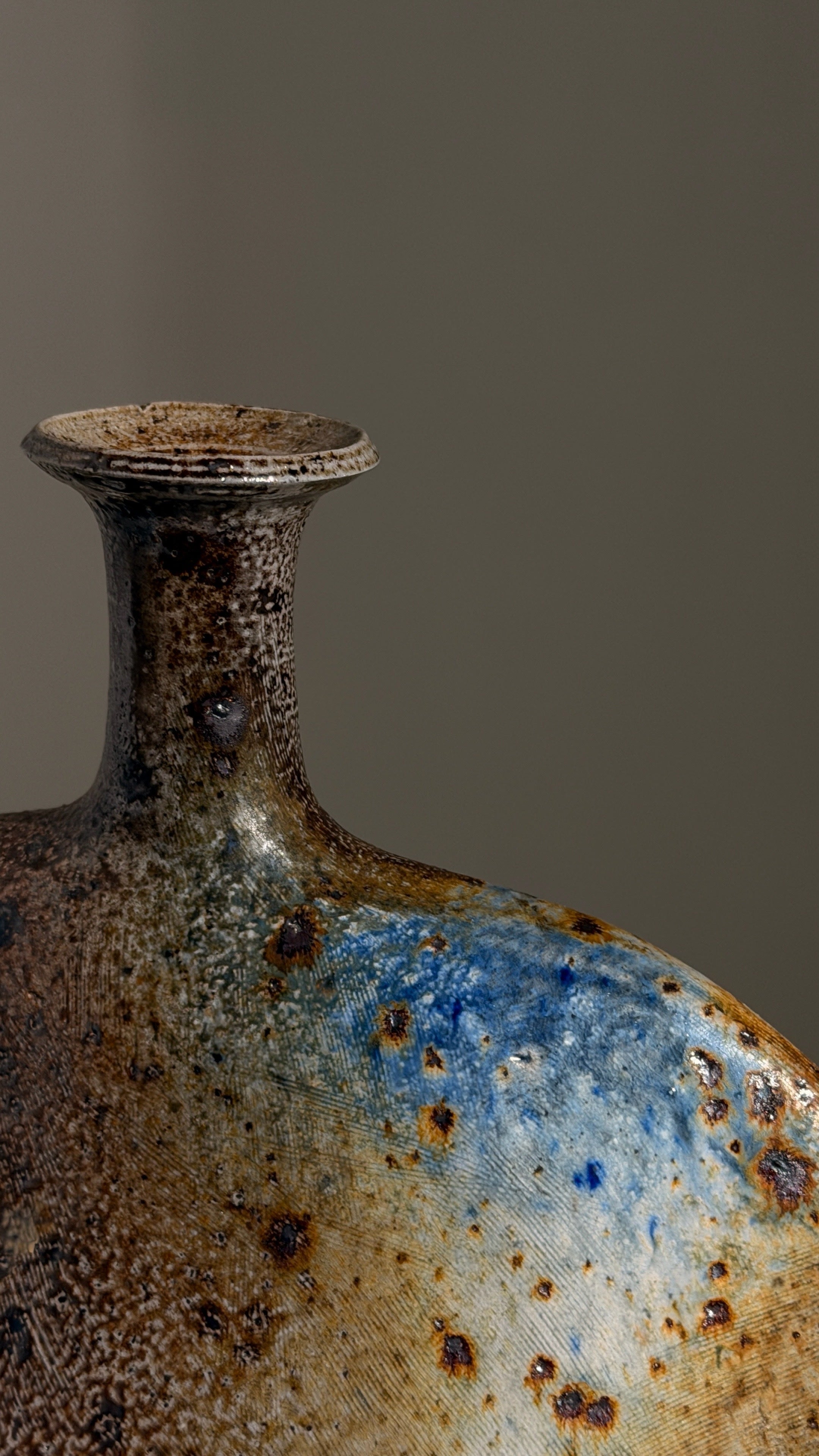Large bottle vase by Gustave Tiffoche — top view highlighting ceramic texture