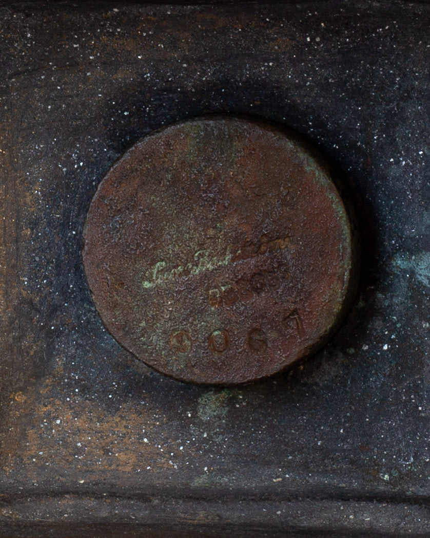 Bronze candleholder base detail showing Sune Bäckström signature