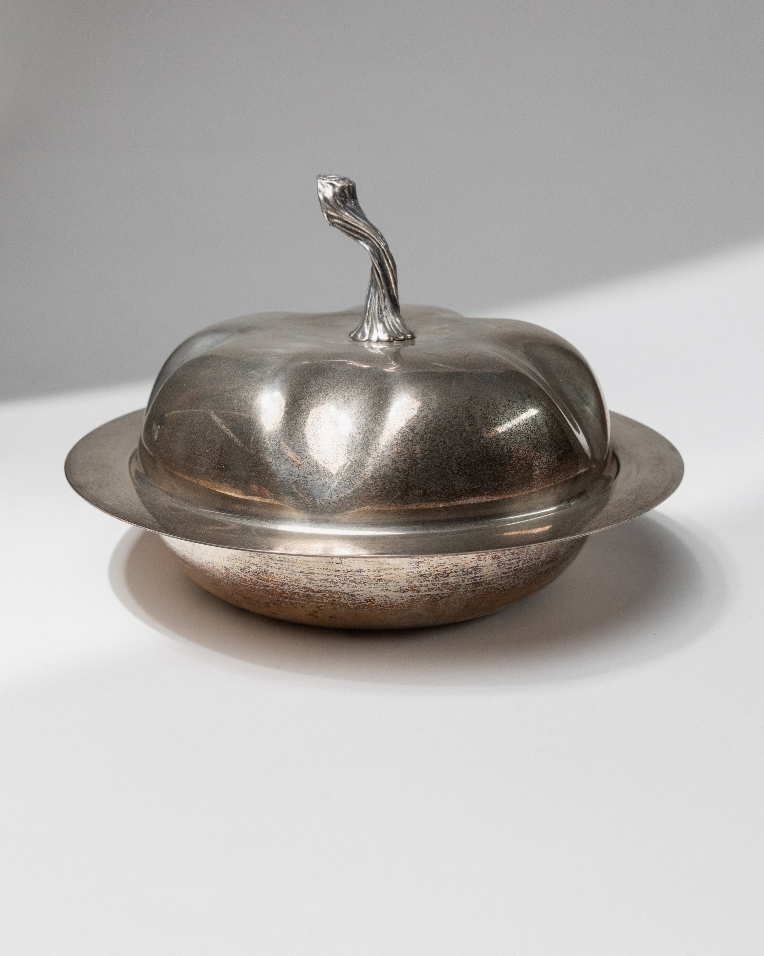 Vintage silver-plated serving bowl with domed lid and curved handle