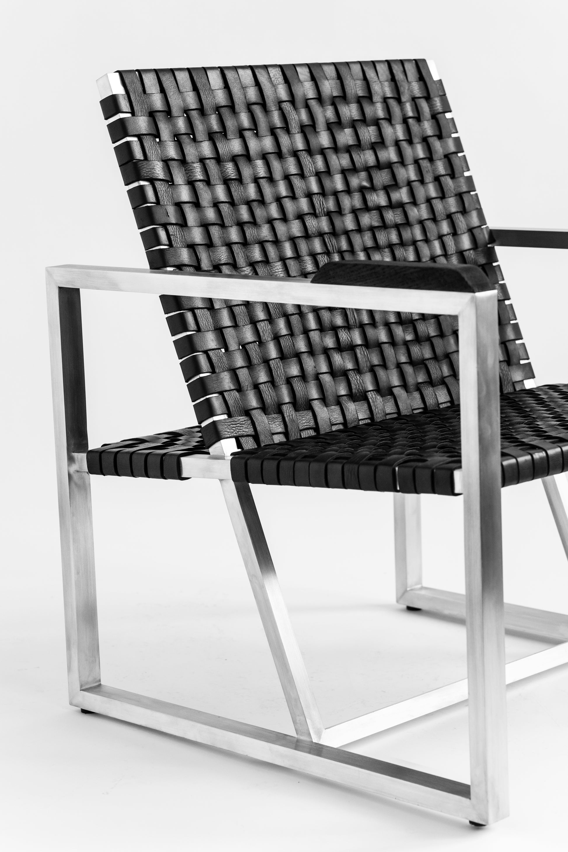 RIA II Lounge Chair — angled view showing woven black seat and metal frame