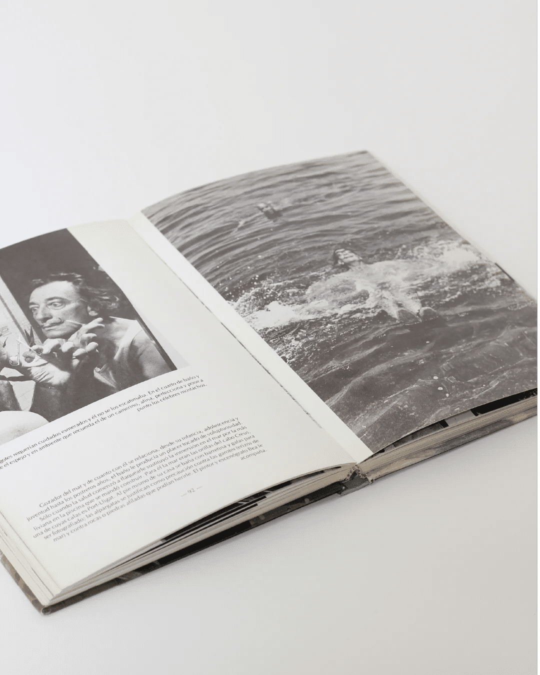 Aquel Dali Book — open on white surface with black and white images