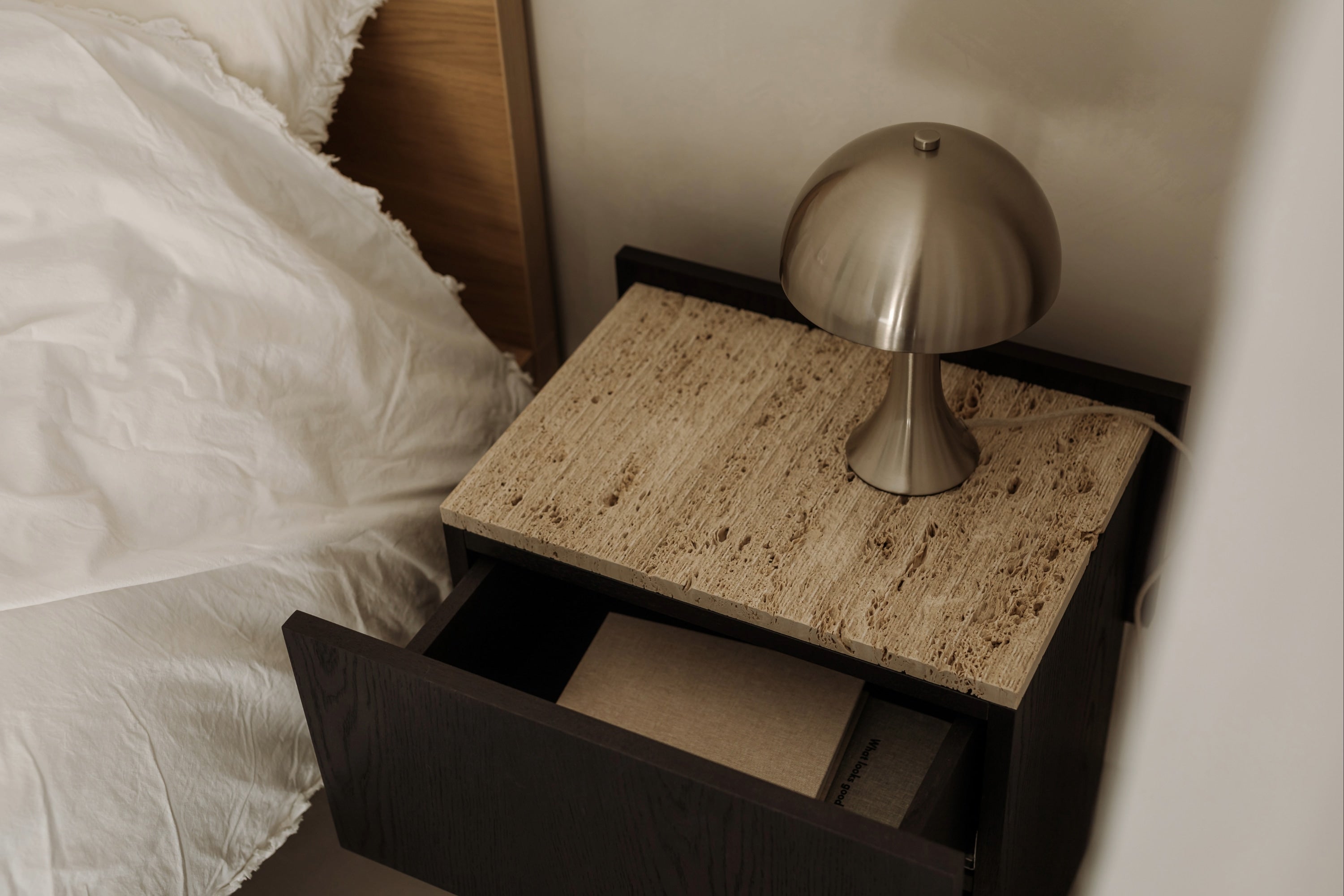 NOTO Night Stand — top view with textured stone surface and lamp