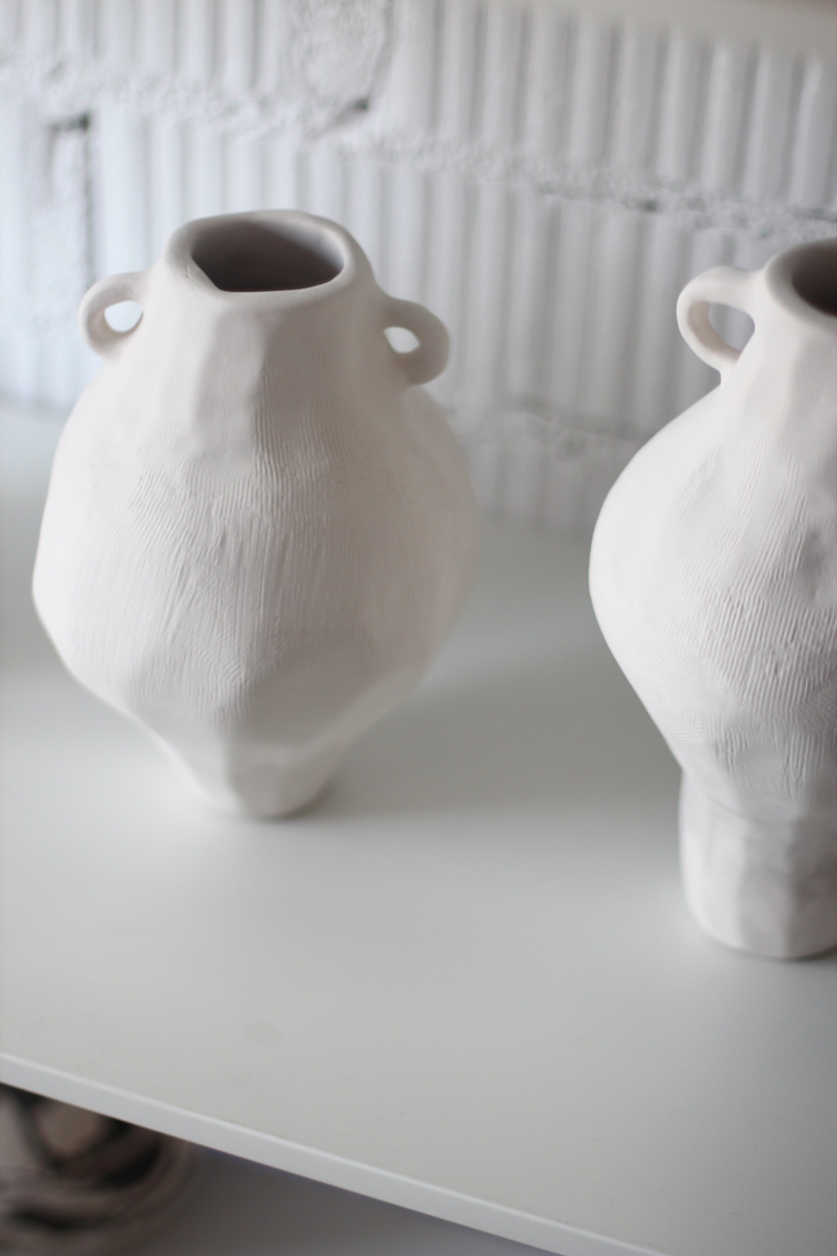 Ceramic Vase Cos 03 — two white vases on shelf