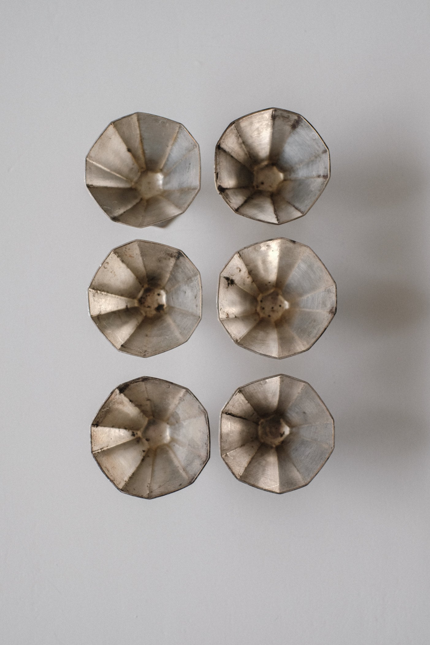 Art Deco Small Cups — overhead view of metallic cups arranged in grid