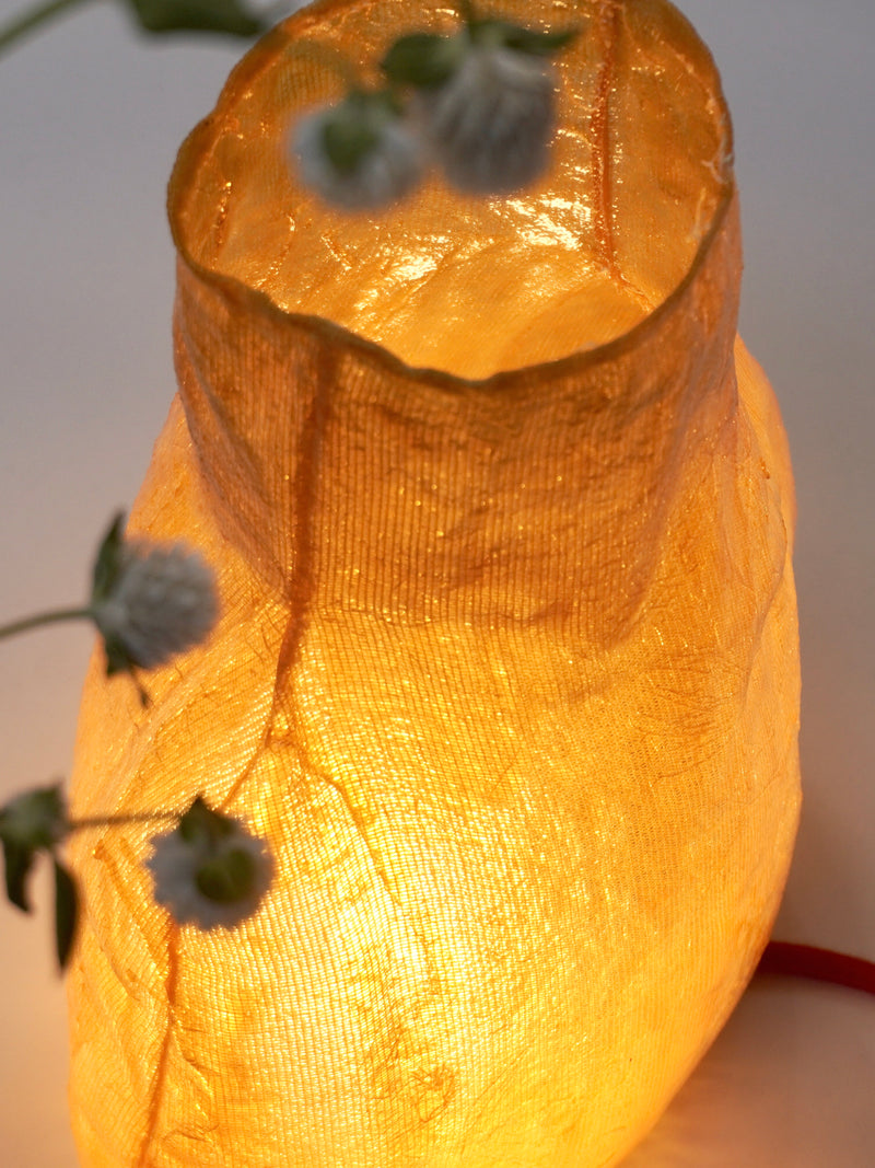 Moonlight Table Lamp — close-up of warm amber fabric shade