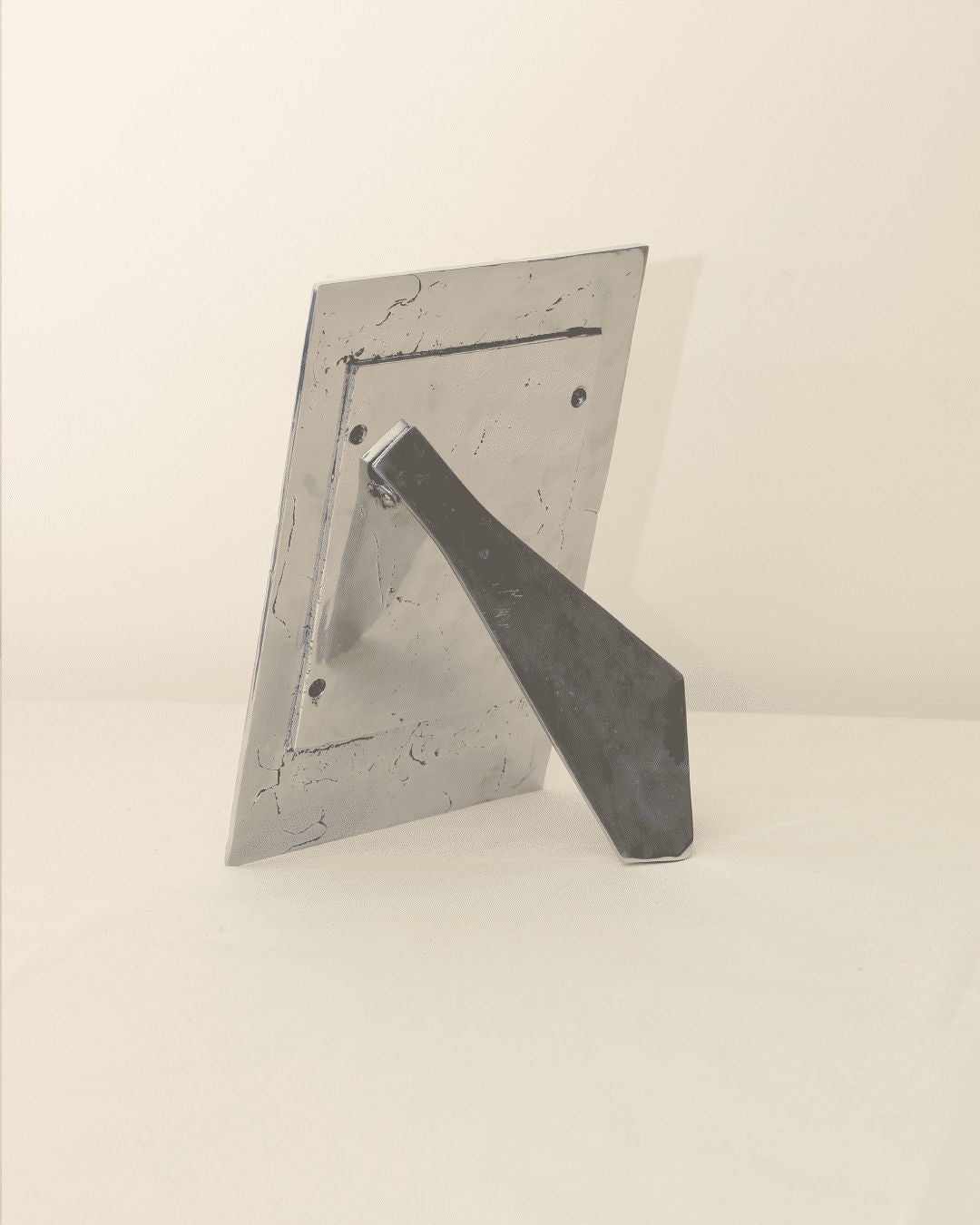Brutalist Portrait Holder — angled view showing metal base and stand