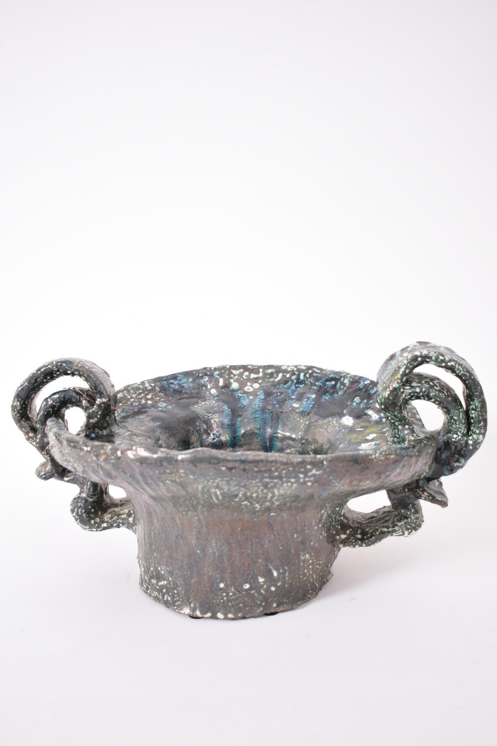 The Barracuda Interiors Helder Handles Large Ceramic Bowl, 2025, features a metallic, textured finish with two curled handles—ideal for stylish table settings.