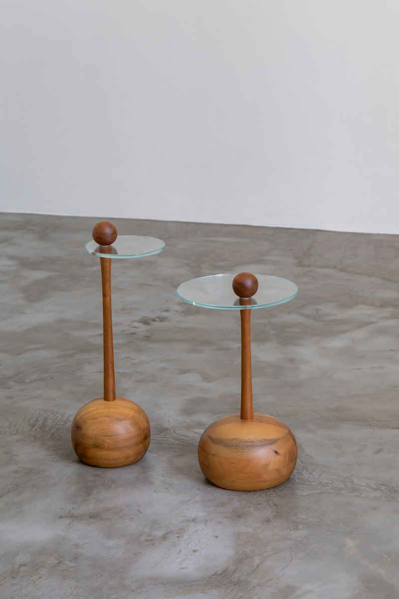 Serena wooden side tables with glass tops and spherical accents