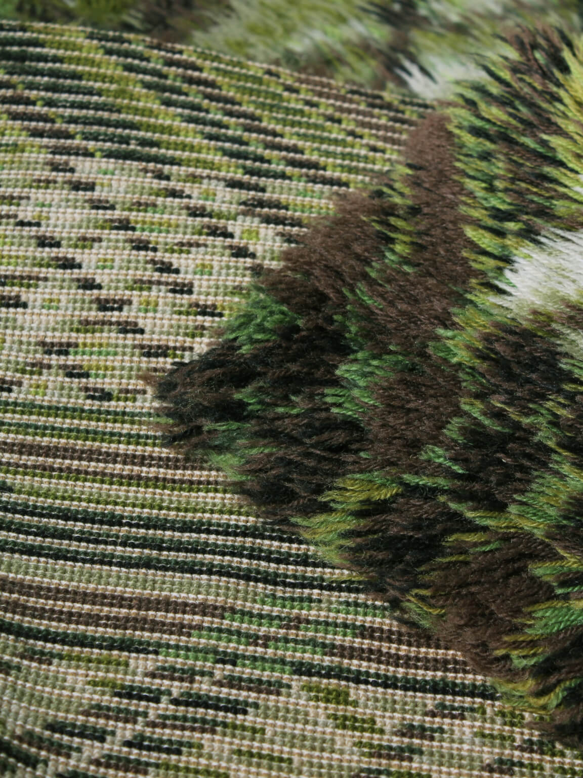 Marianne Richter "Kolmården" Pure Wool Rya Rug, 135x200cm — close-up of textured green and brown fibers