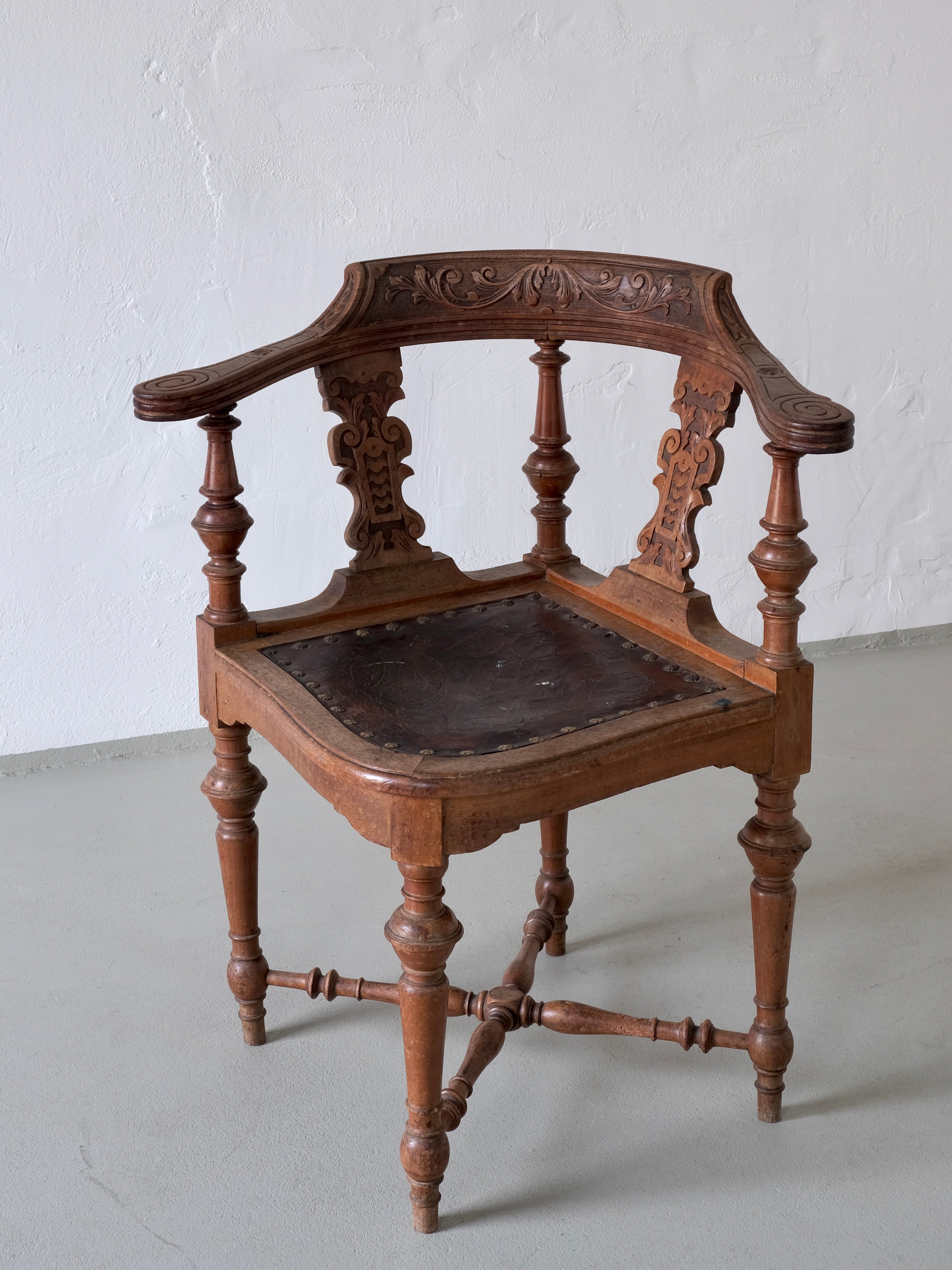Antique Carved Corner Chair with Leather Seat