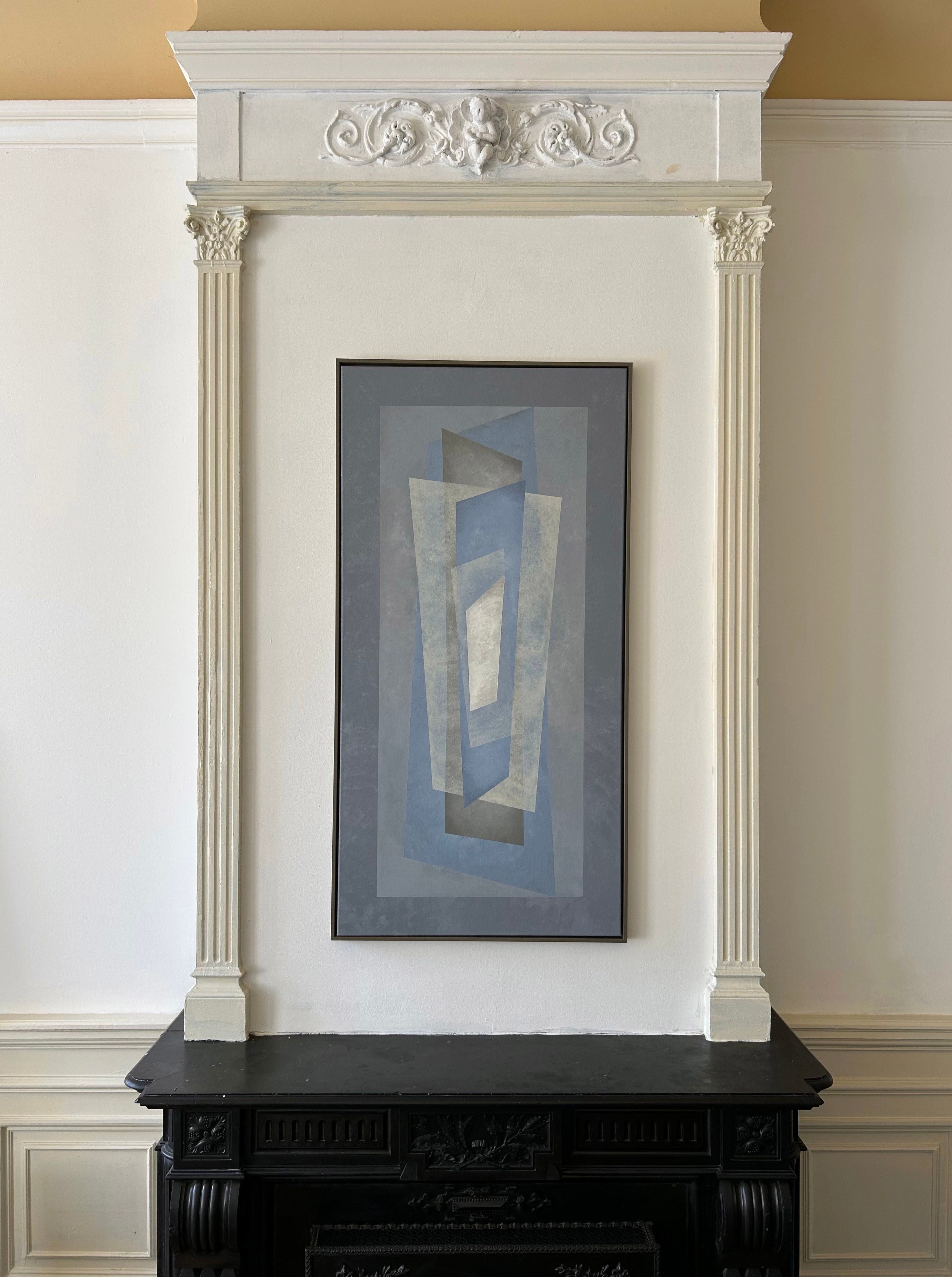 The "Floating" painting by Iris Bavelaar, featuring blue and gray geometric rectangles, hangs above an ornate black fireplace framed with white decorative molding.