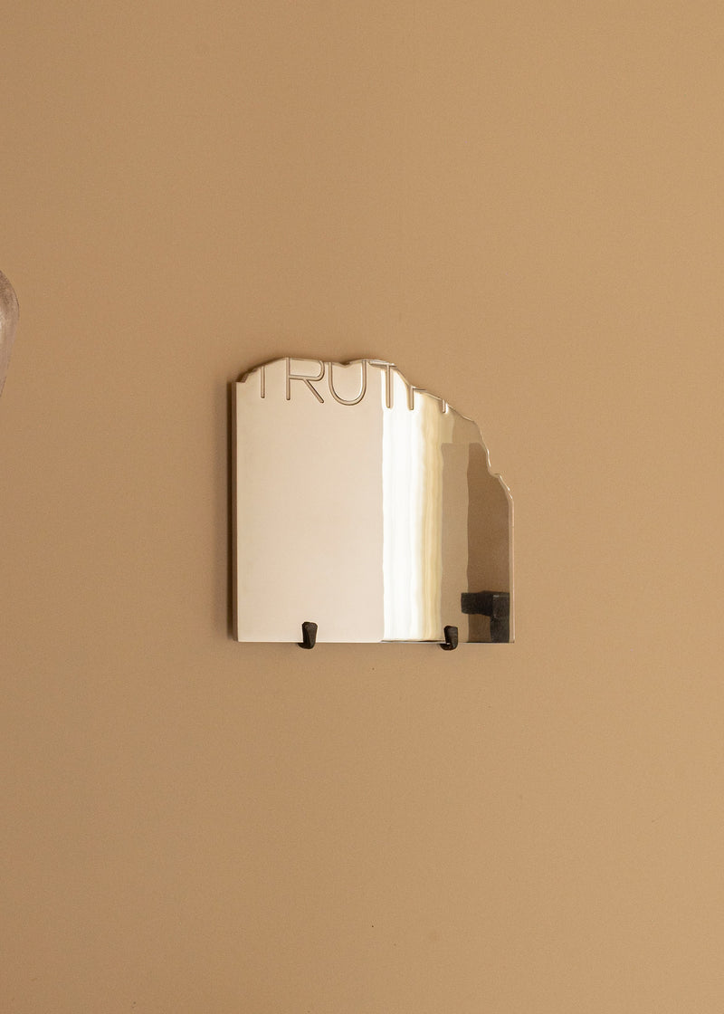 THE TRUTH - Contemporary Mirror — close-up of reflective surface on wall