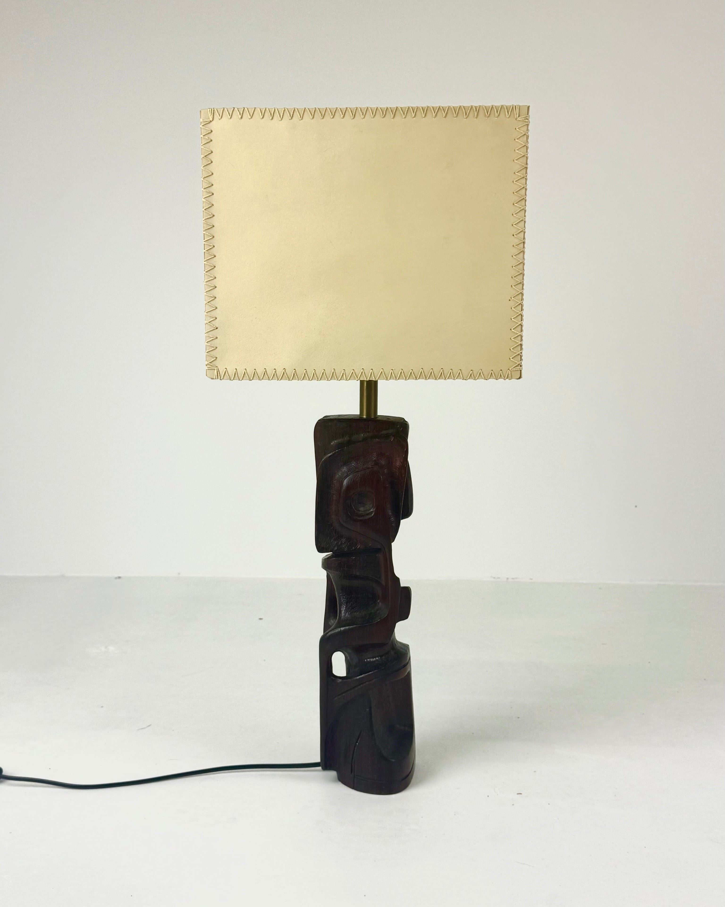 Hand-carved wooden sculptural table lamp by Gianni Pinna — lifestyle setting