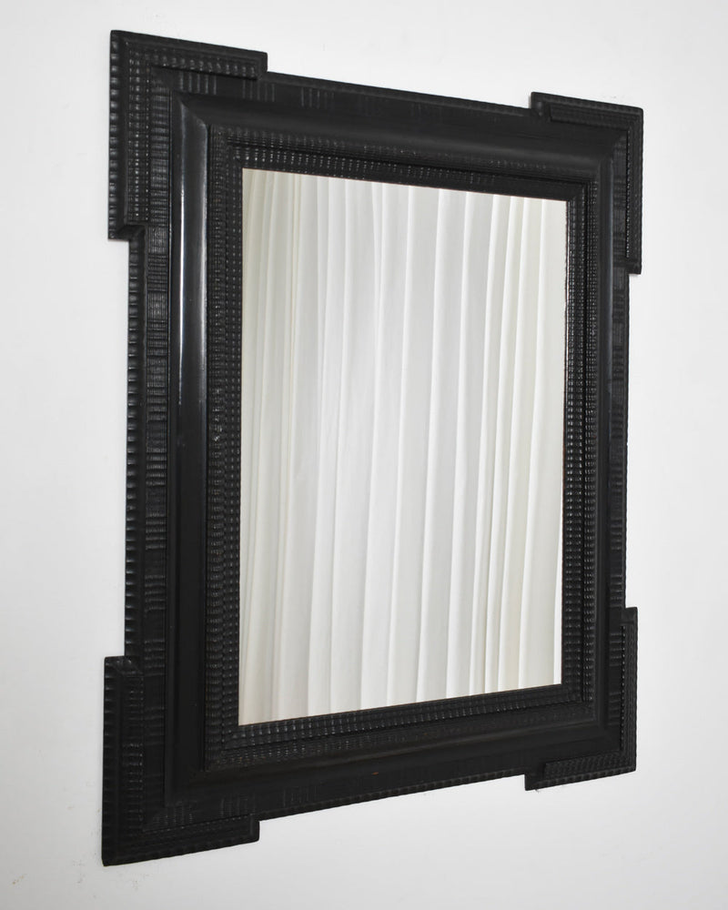 Carved ebonised wooden mirror, XIXth c. — detail view